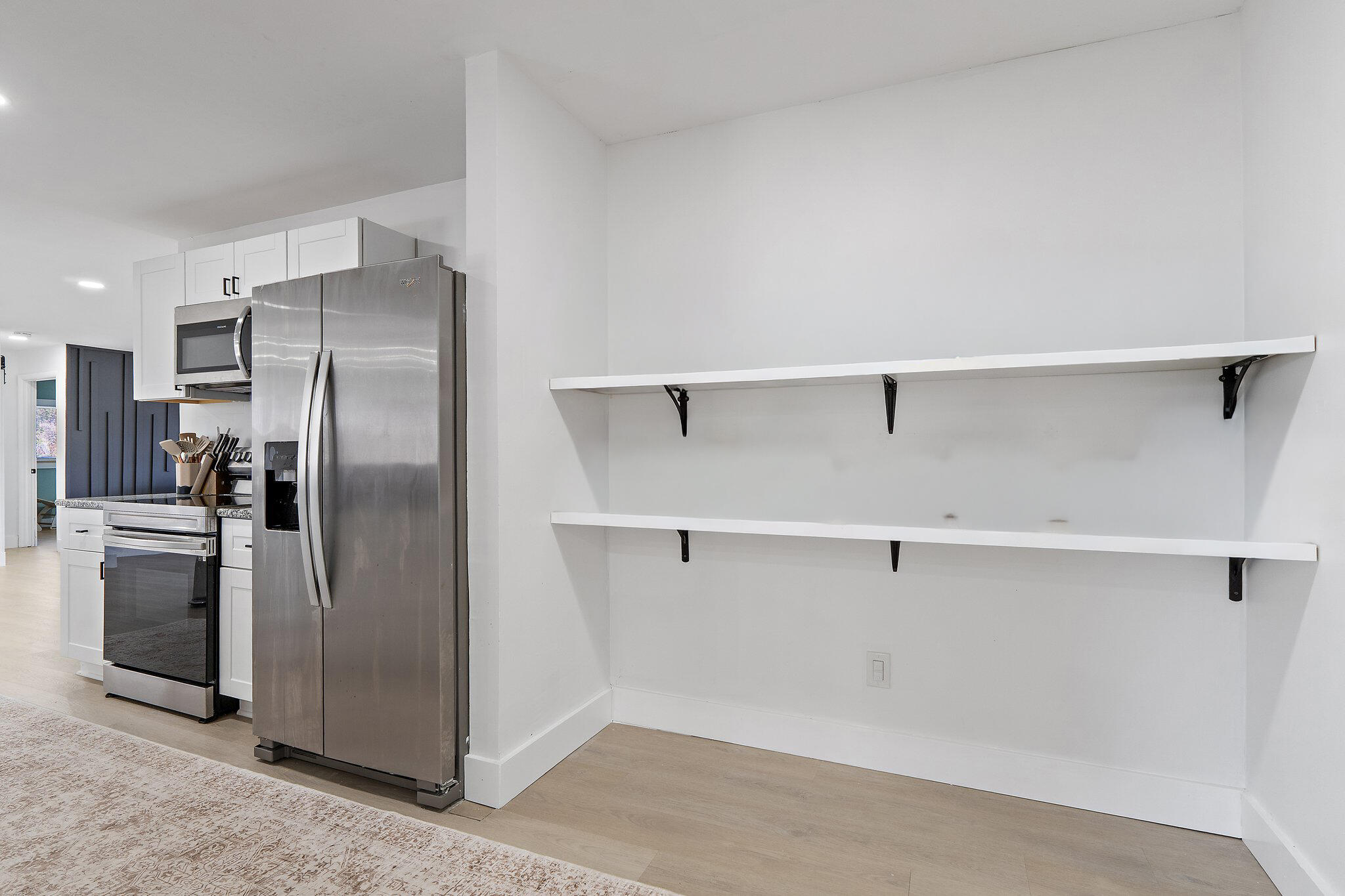 1851 Southeast Jackson Street Stuart, FL 34997 - Photo 18 of 61 a view of a refrigerator in kitchen and an empty room