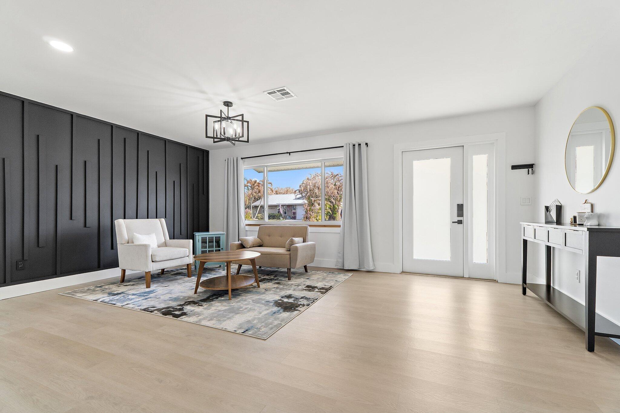 1851 Southeast Jackson Street Stuart, FL 34997 - Photo 2 of 61 a living room with furniture window and wooden floor