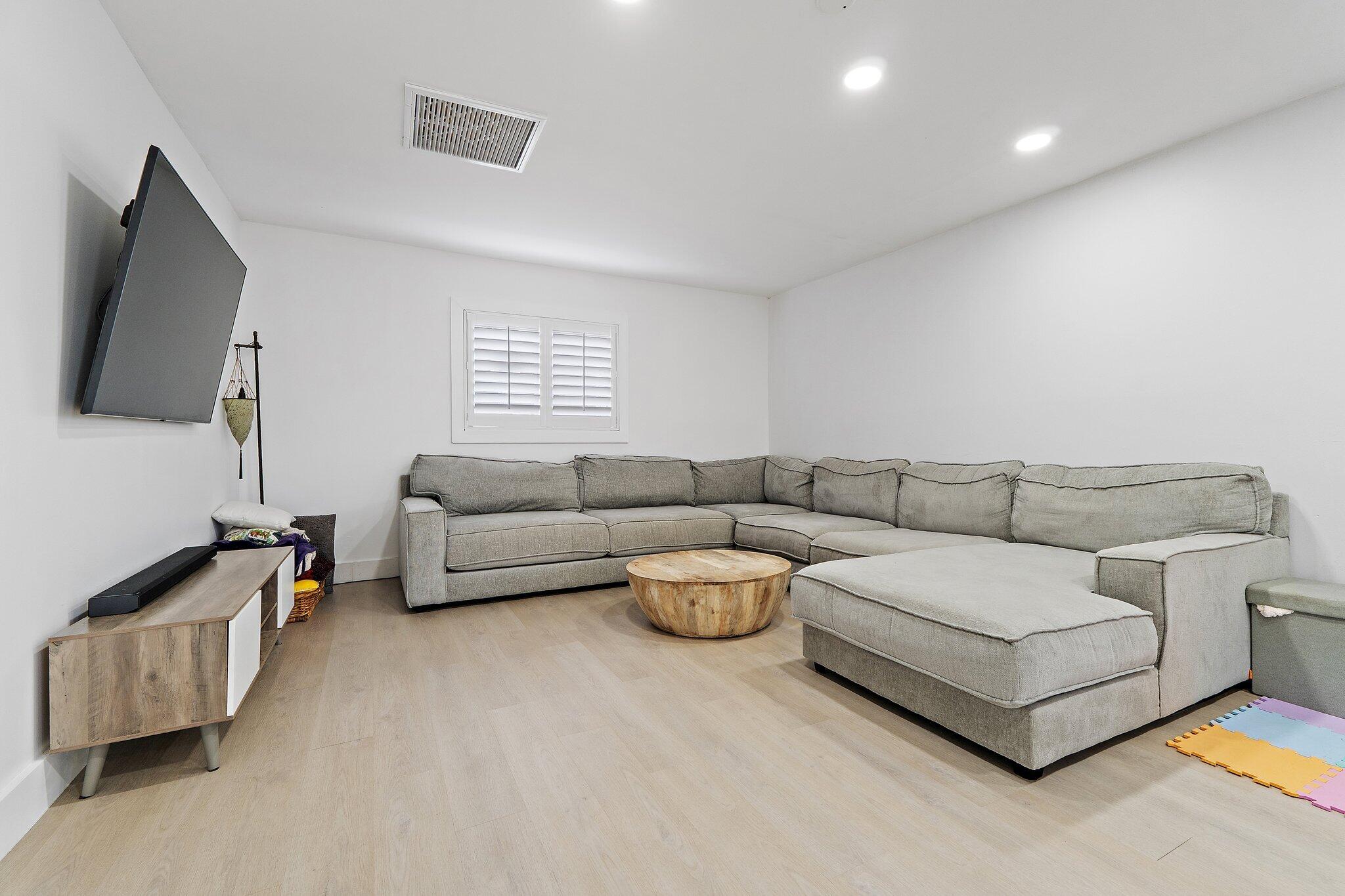 1851 Southeast Jackson Street Stuart, FL 34997 - Photo 24 of 61 a living room with furniture and a flat screen tv