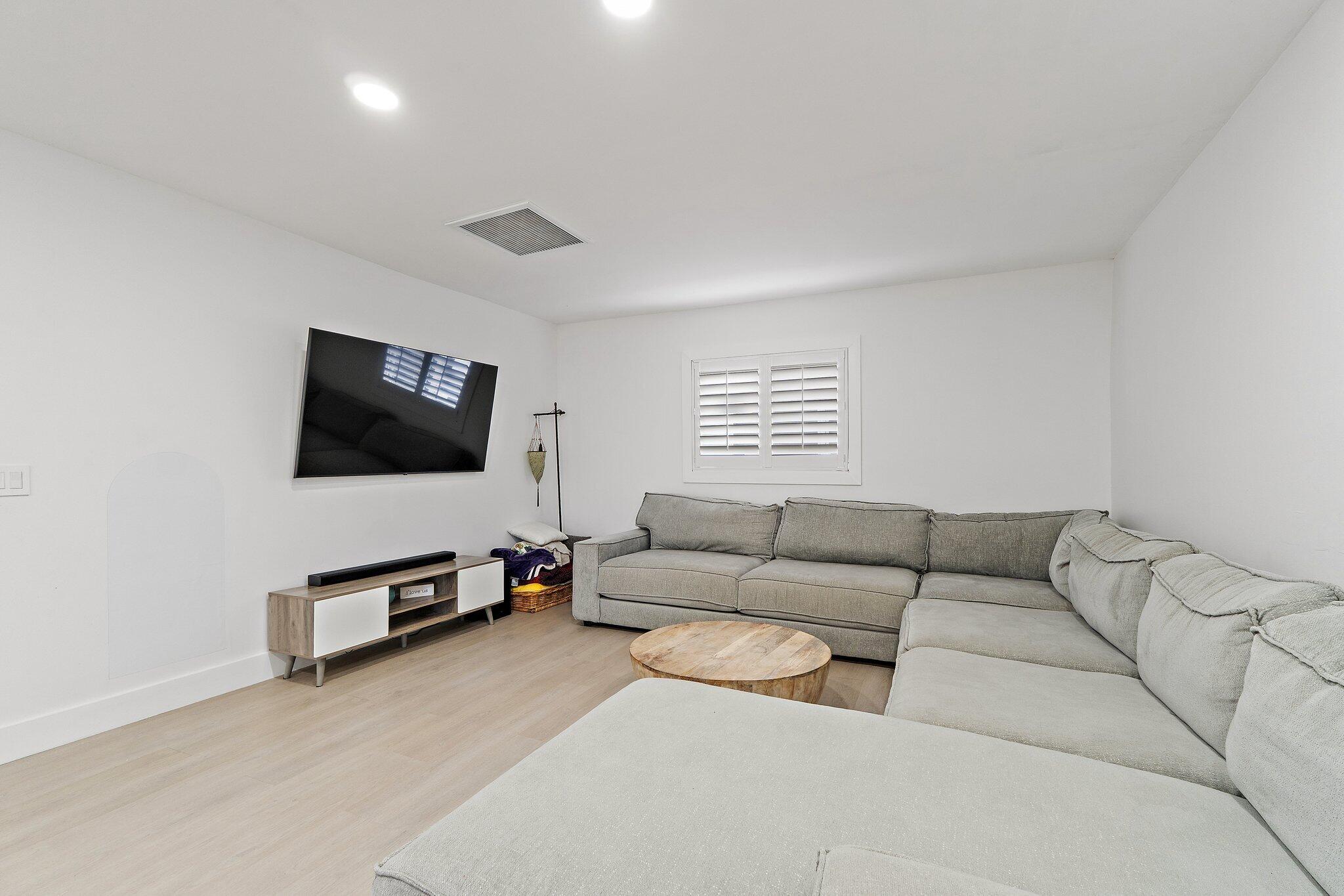 1851 Southeast Jackson Street Stuart, FL 34997 - Photo 25 of 61 a living room with furniture and a flat screen tv