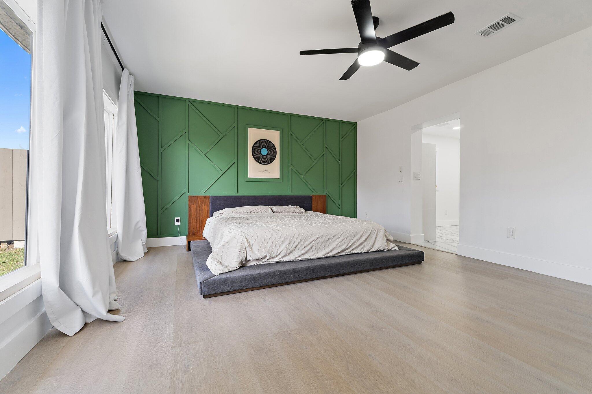 1851 Southeast Jackson Street Stuart, FL 34997 - Photo 27 of 61 a bedroom with a bed and a window