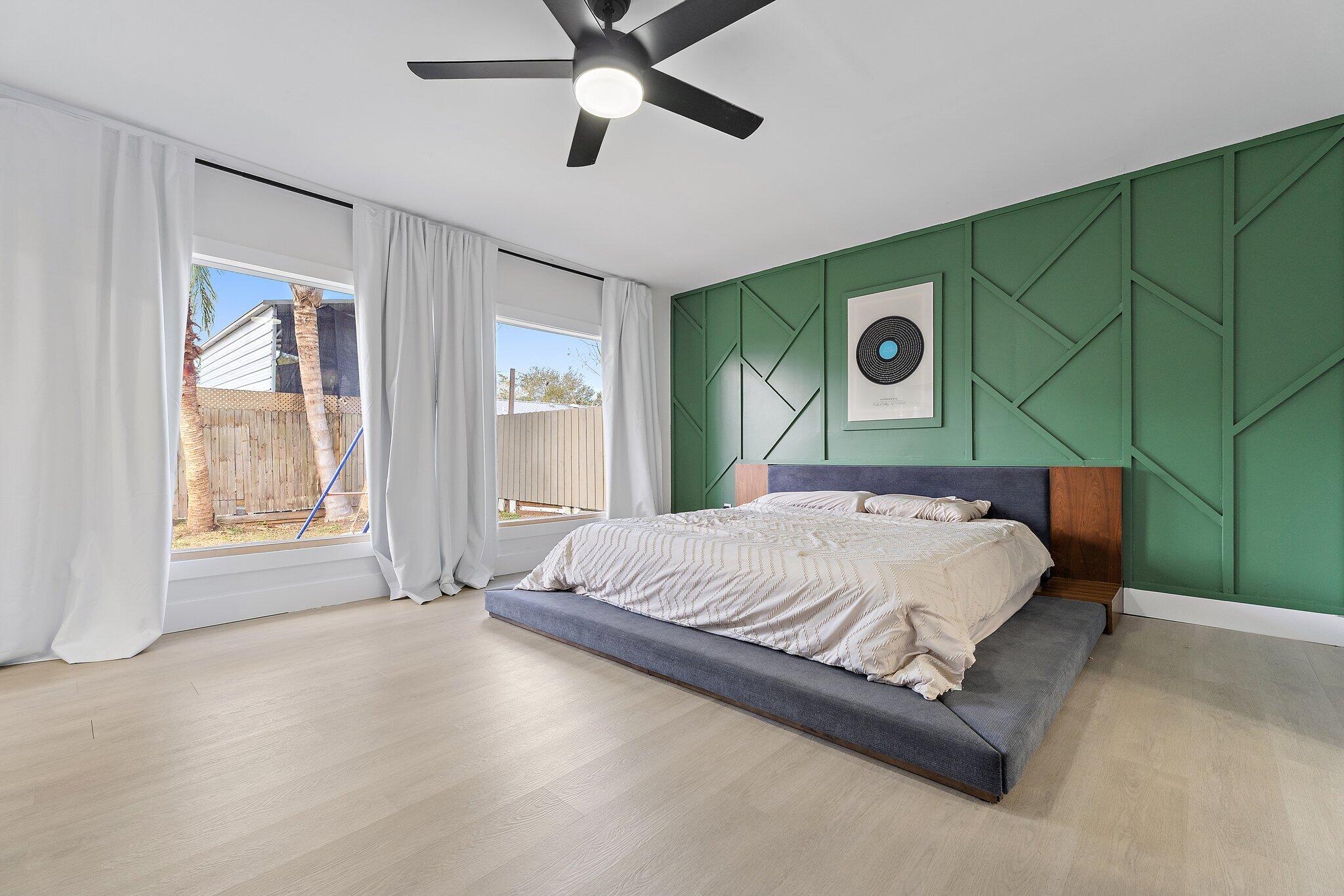 1851 Southeast Jackson Street Stuart, FL 34997 - Photo 28 of 61 a bed sitting in a spacious bedroom next to a window