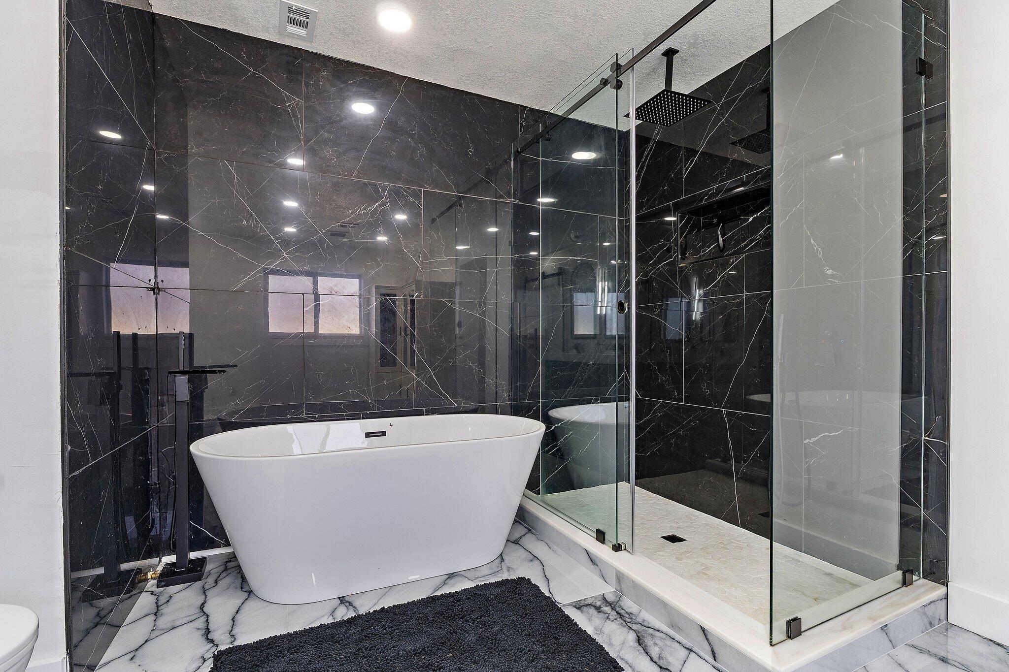 1851 Southeast Jackson Street Stuart, FL 34997 - Photo 31 of 61 a bathroom with a bathtub and shower