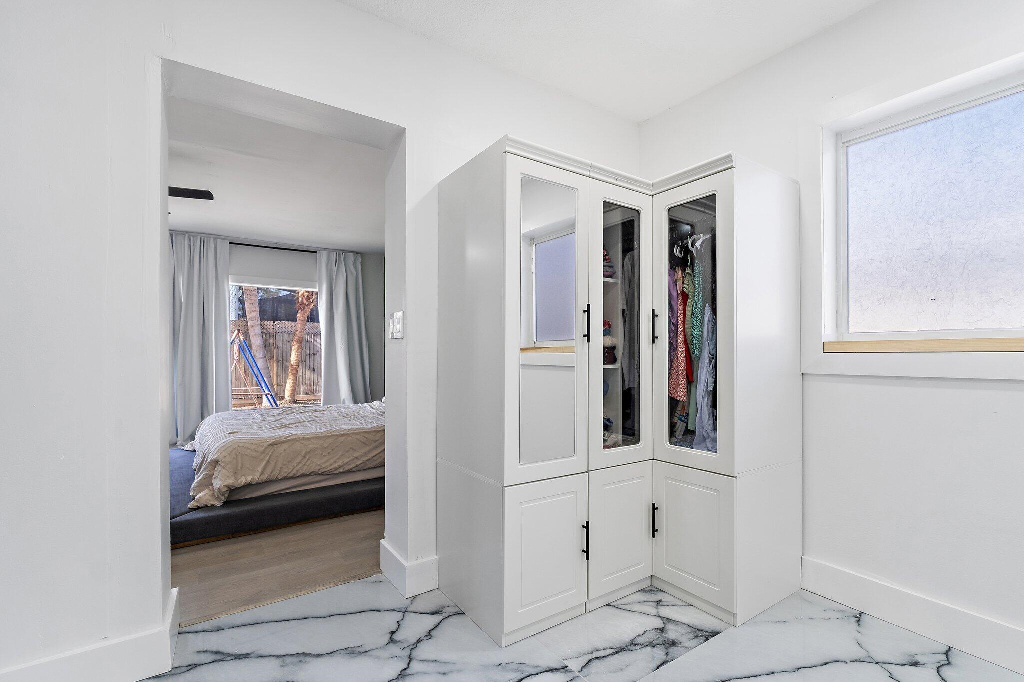 1851 Southeast Jackson Street Stuart, FL 34997 - Photo 35 of 61 a bedroom with a bed and a window