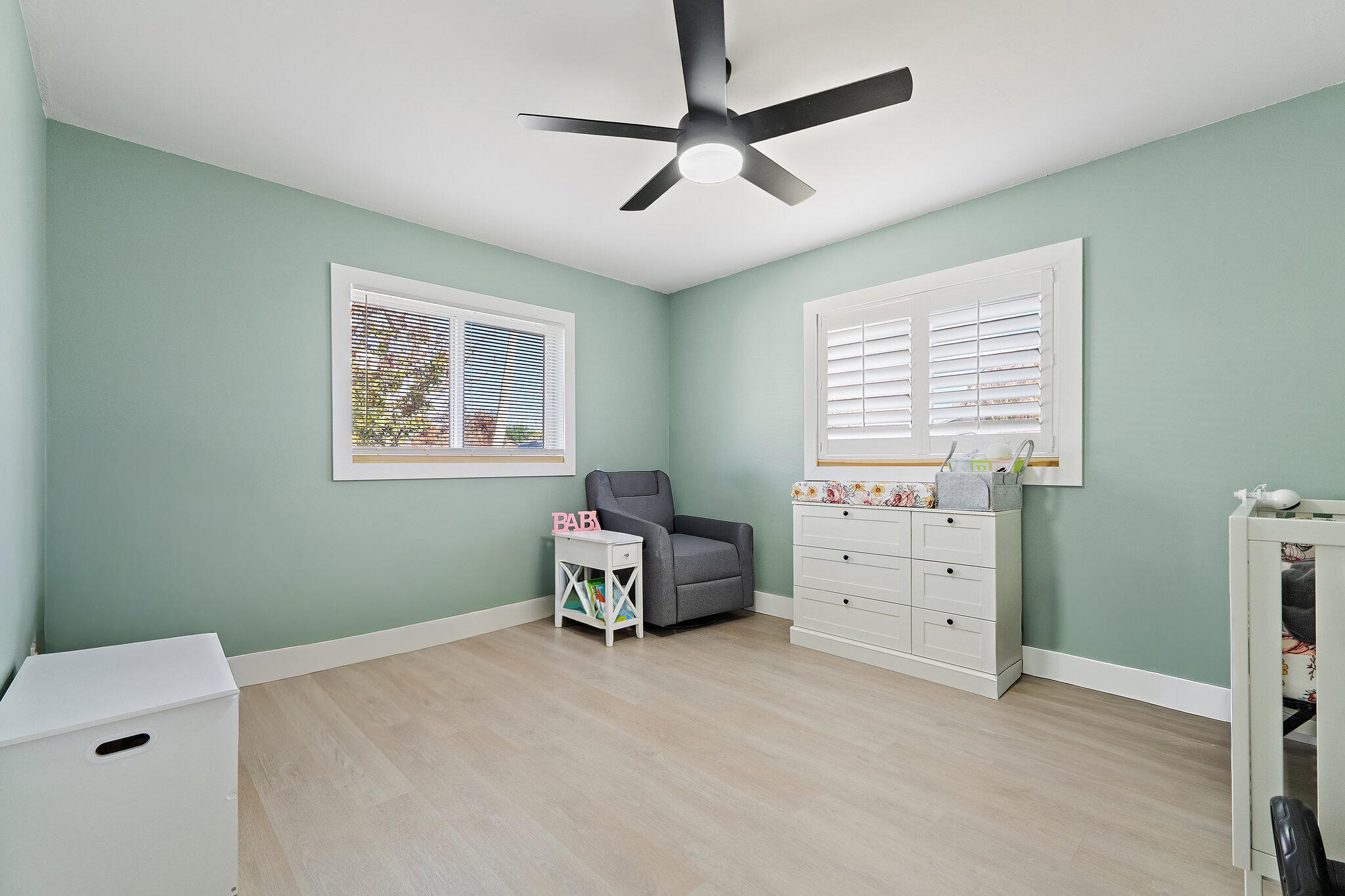 1851 Southeast Jackson Street Stuart, FL 34997 - Photo 36 of 61 a bedroom with a bed and a chandelier