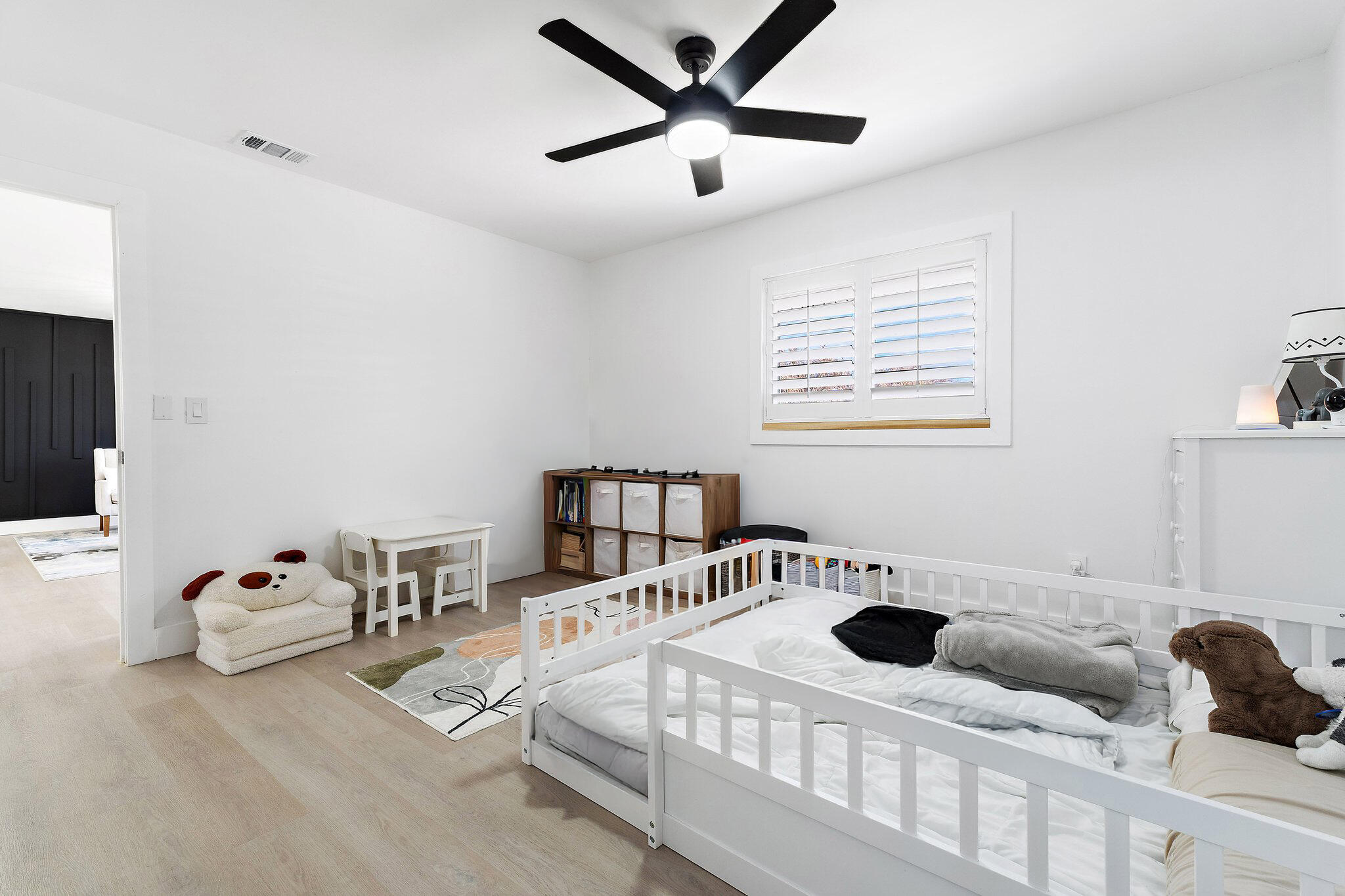 1851 Southeast Jackson Street Stuart, FL 34997 - Photo 40 of 61 a bedroom with a bed and a chandelier