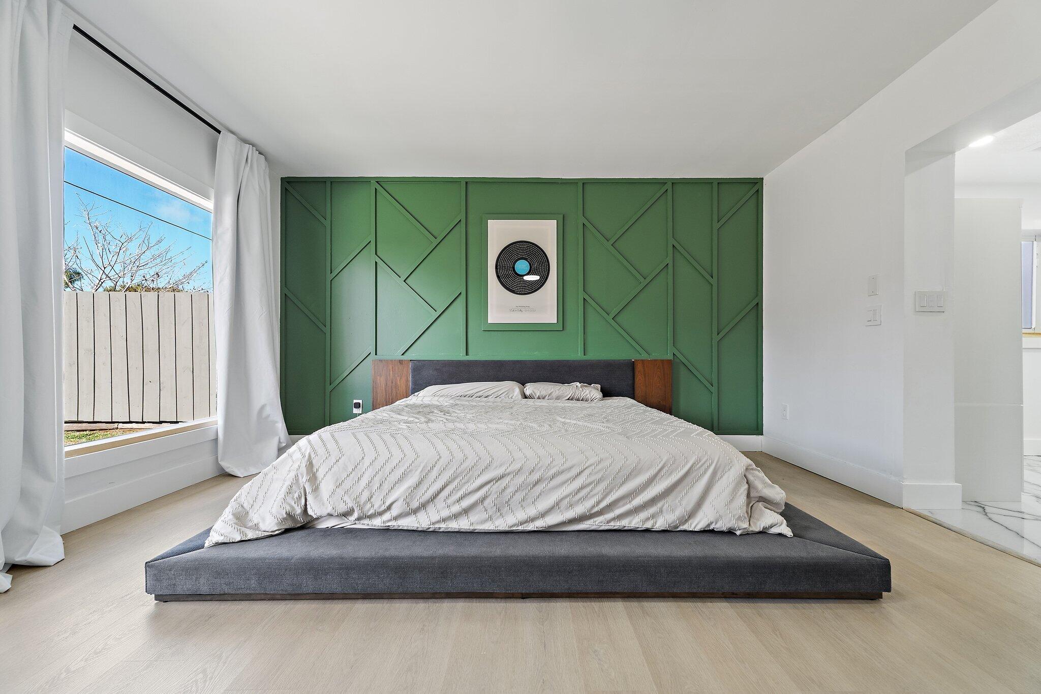 1851 Southeast Jackson Street Stuart, FL 34997 - Photo 4 of 61 a bedroom with a bed and a window