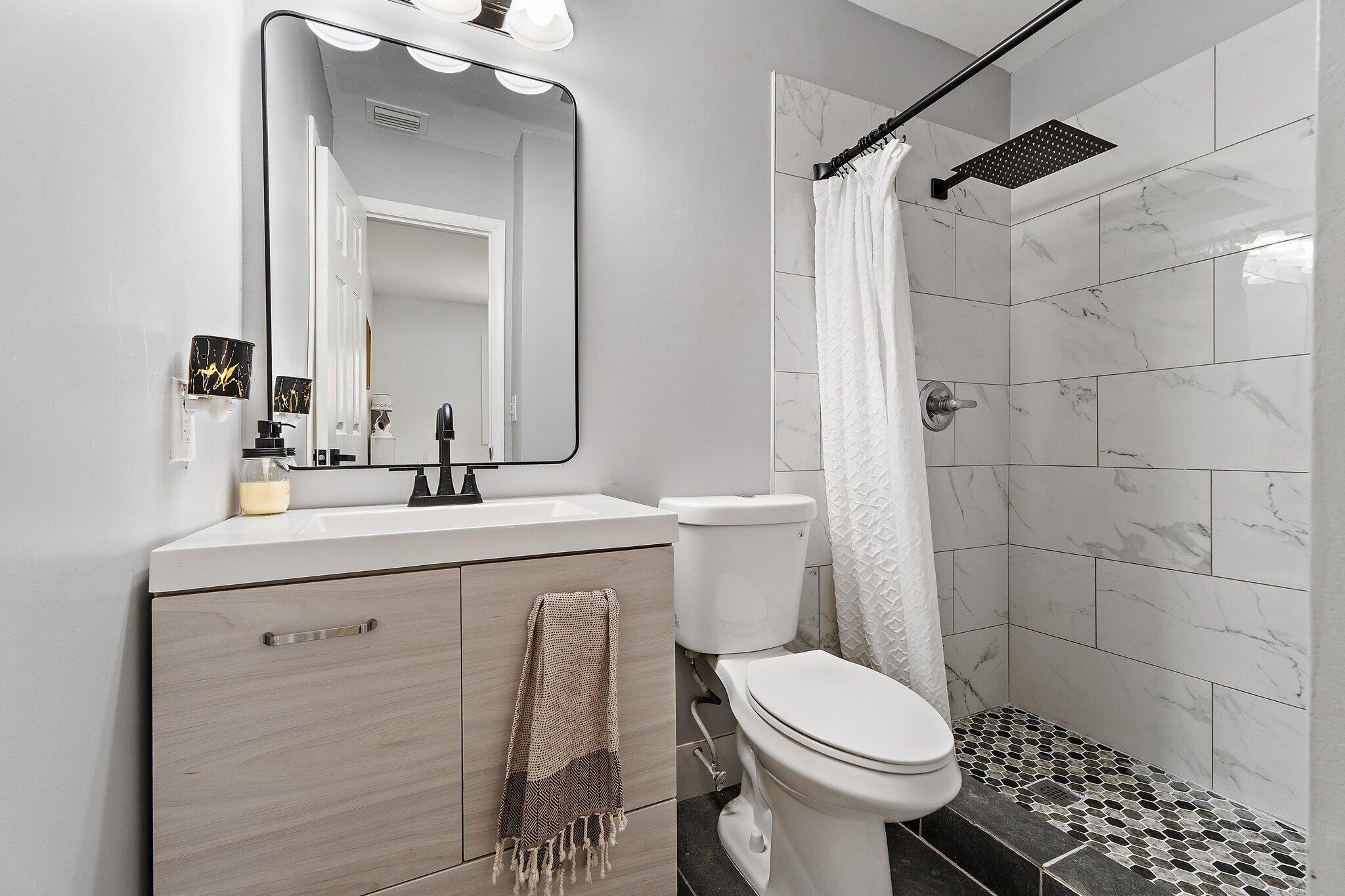 1851 Southeast Jackson Street Stuart, FL 34997 - Photo 42 of 61 a bathroom with a sink toilet and shower