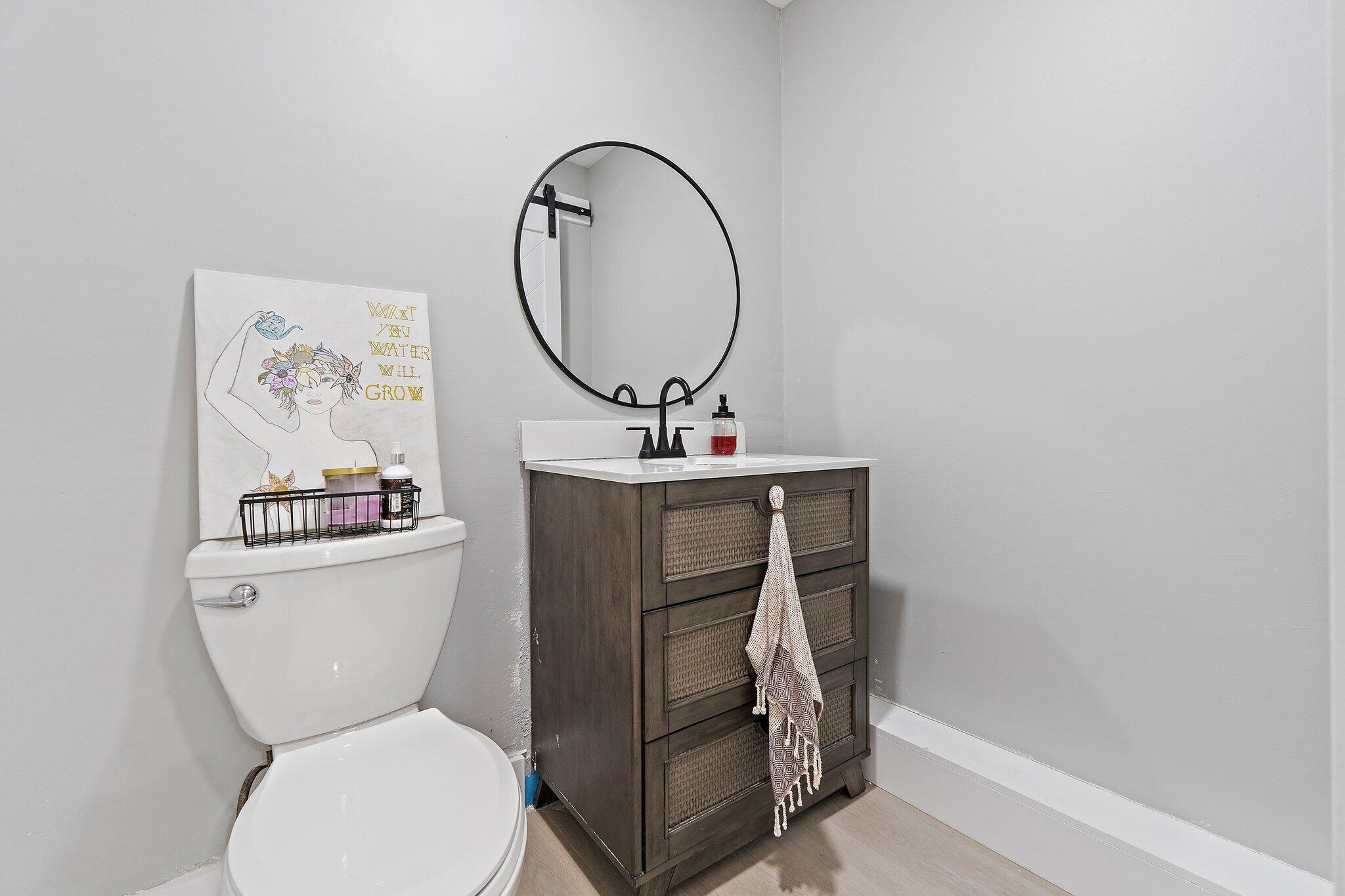 1851 Southeast Jackson Street Stuart, FL 34997 - Photo 45 of 61 a bathroom with a toilet sink and mirror