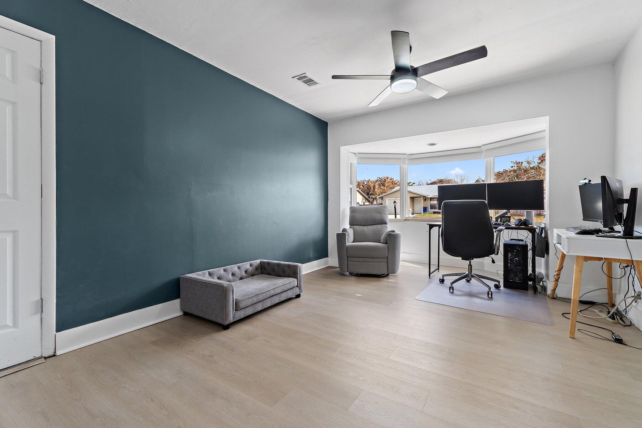 1851 Southeast Jackson Street Stuart, FL 34997 - Photo 46 of 61 a living room with furniture a air conditioner vent and a window