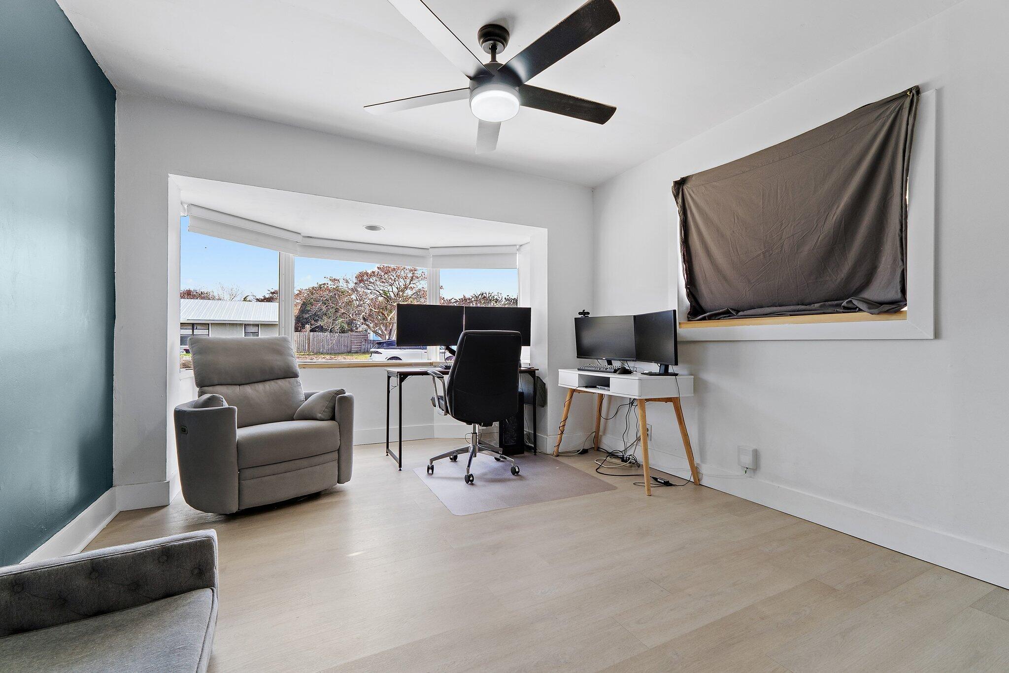 1851 Southeast Jackson Street Stuart, FL 34997 - Photo 47 of 61 a living room with furniture and a flat screen tv