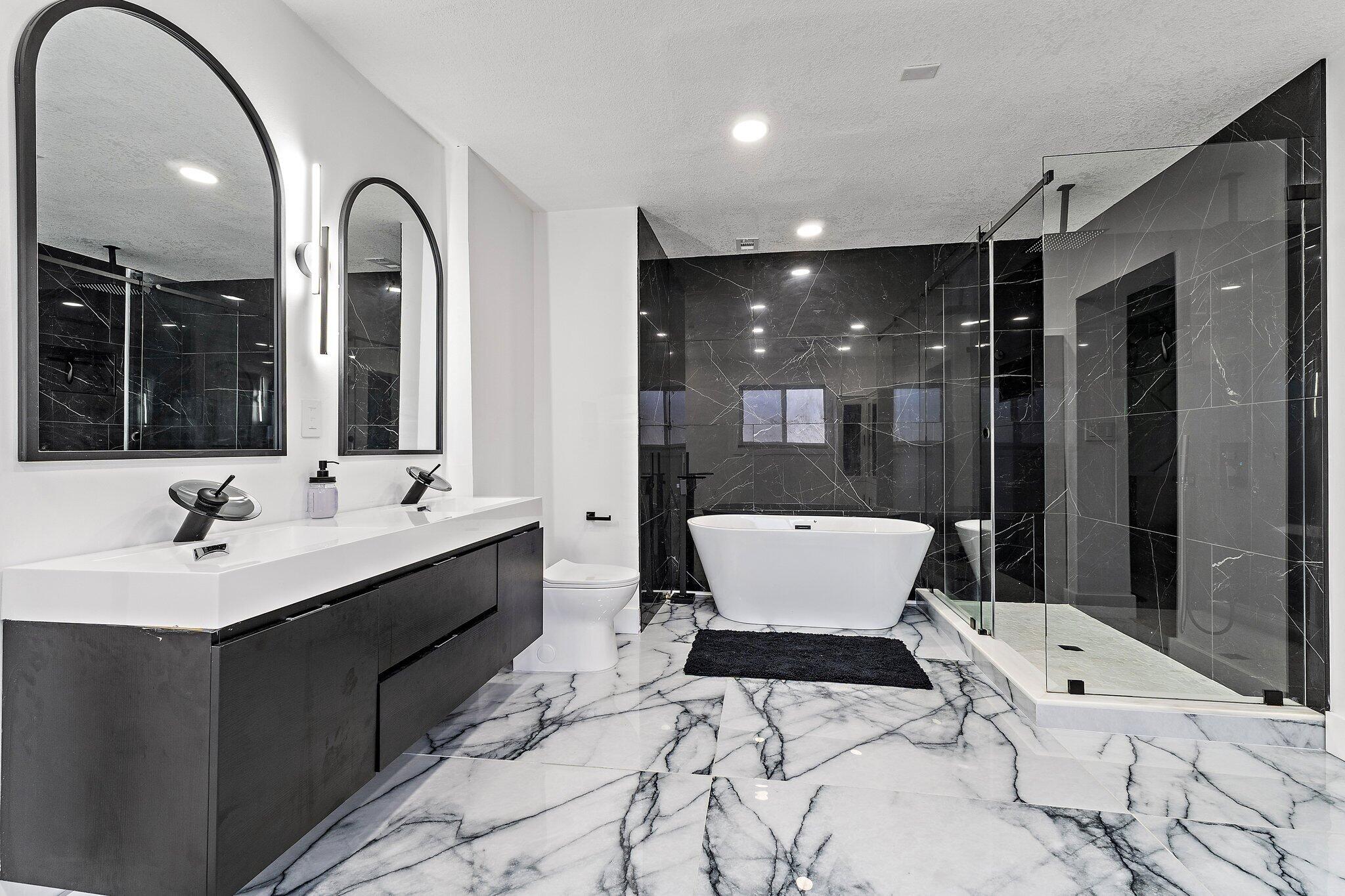 1851 Southeast Jackson Street Stuart, FL 34997 - Photo 5 of 61 a bathroom with a sink mirror and a bathtub