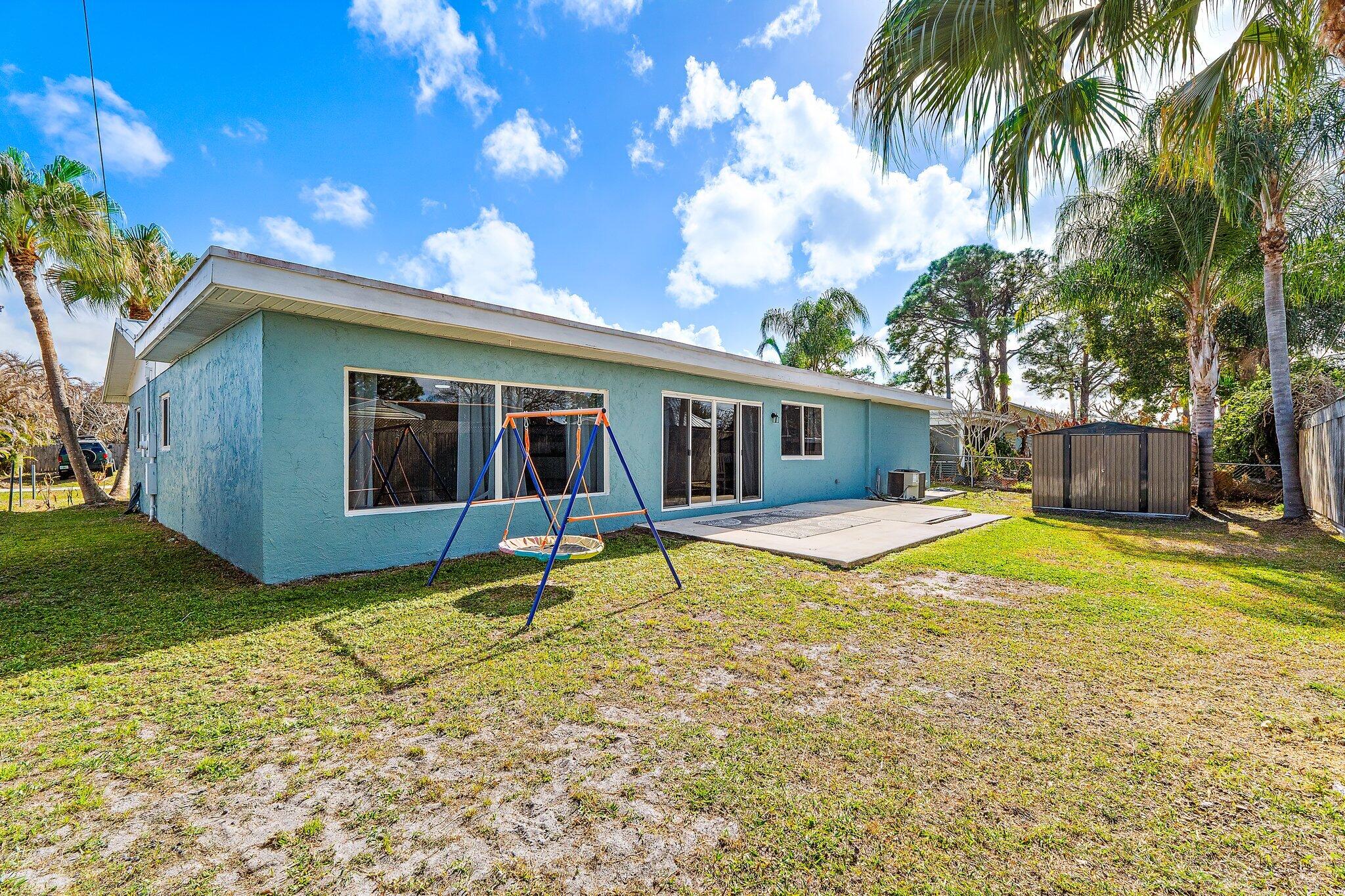 1851 Southeast Jackson Street Stuart, FL 34997 - Photo 53 of 61 a view of a house with swimming pool and a yard
