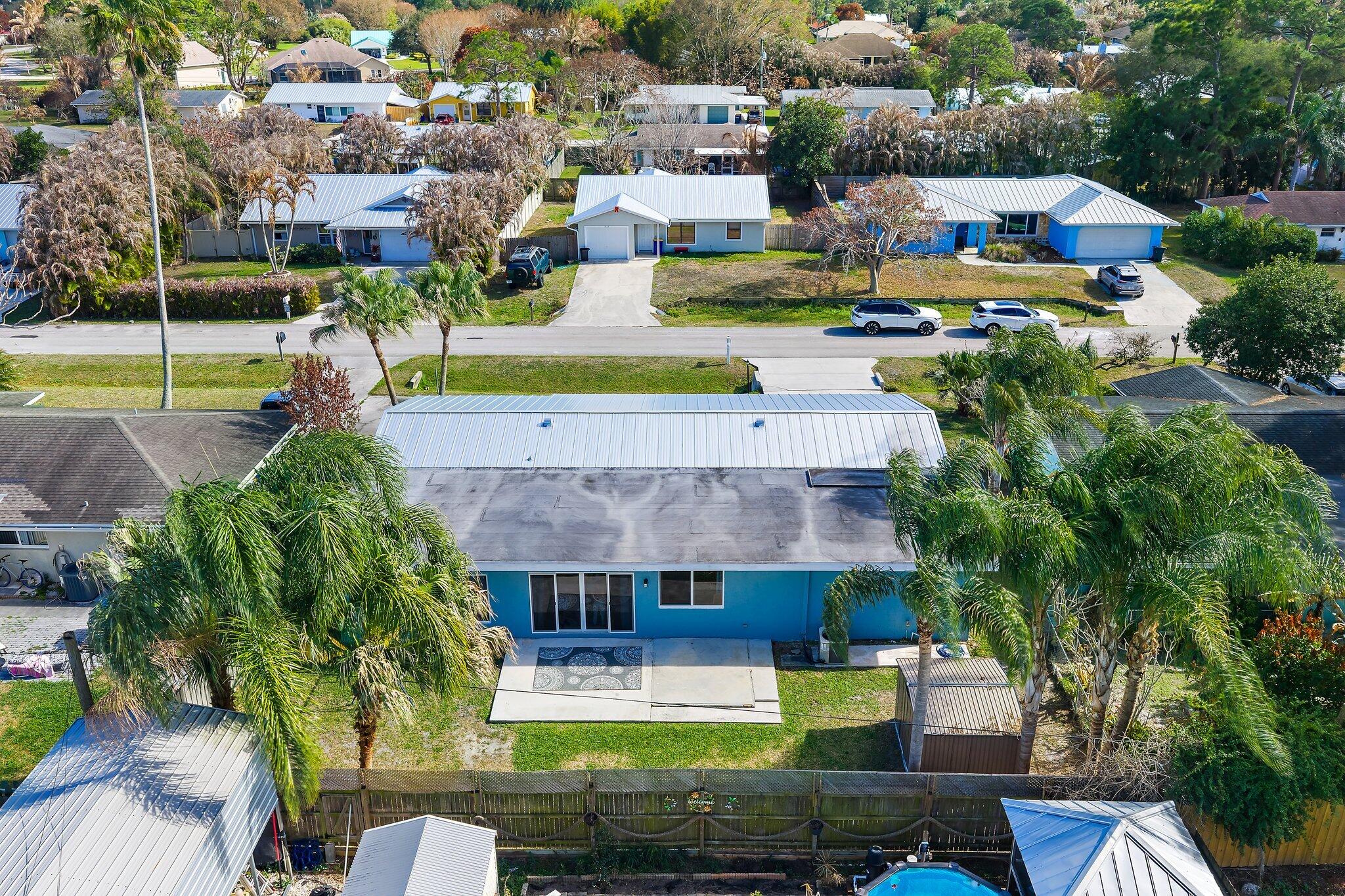 1851 Southeast Jackson Street Stuart, FL 34997 - Photo 58 of 61 a aerial view of a house with swimming pool and a yard