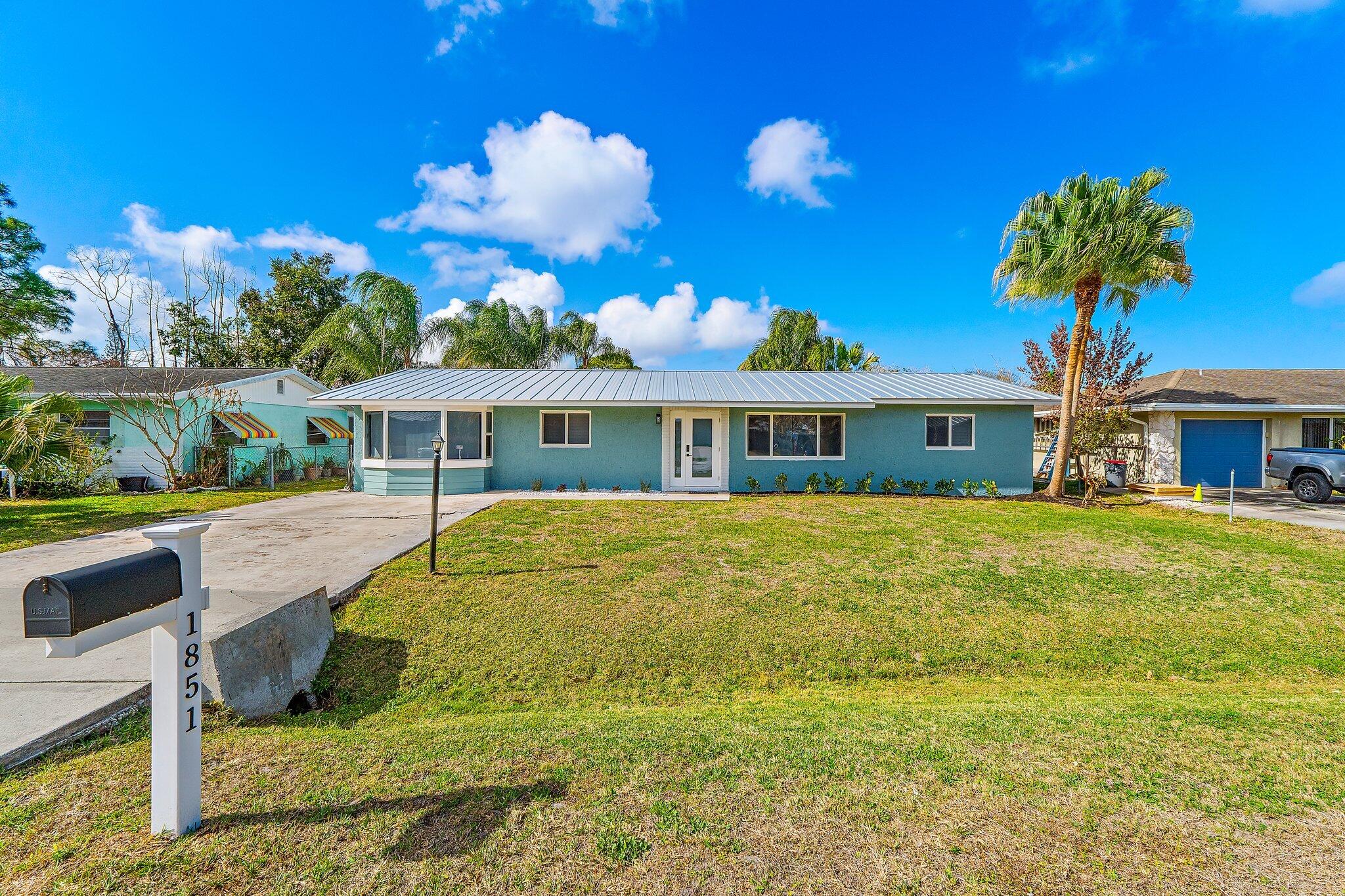 1851 Southeast Jackson Street Stuart, FL 34997 - Photo 6 of 61 a front view of house with yard swimming pool and outdoor seating