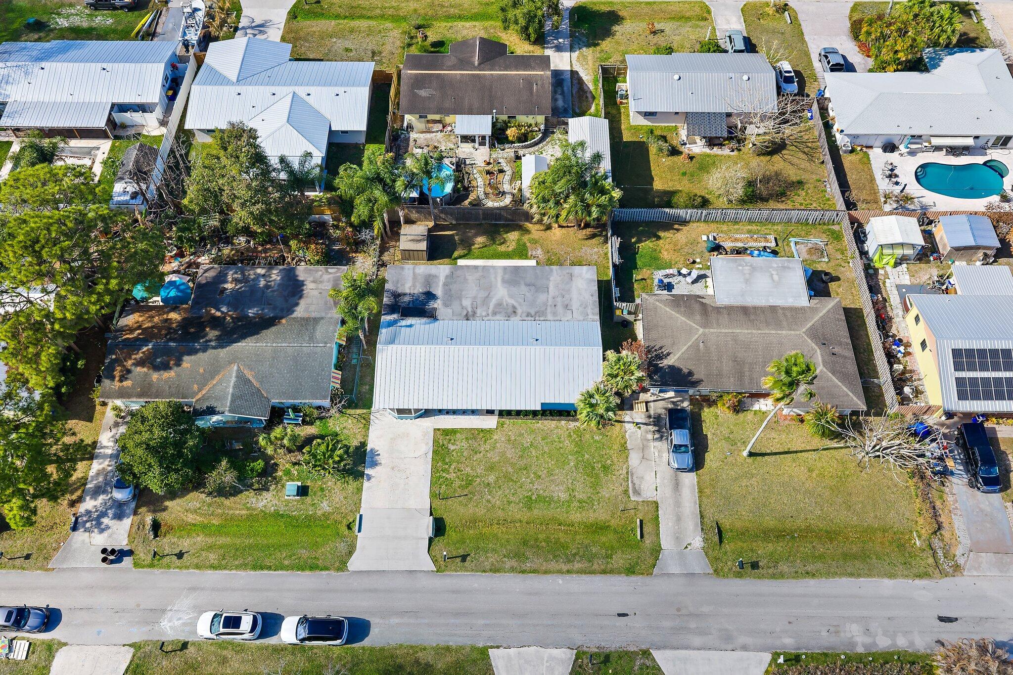 1851 Southeast Jackson Street Stuart, FL 34997 - Photo 61 of 61 an aerial view of residential houses with outdoor space