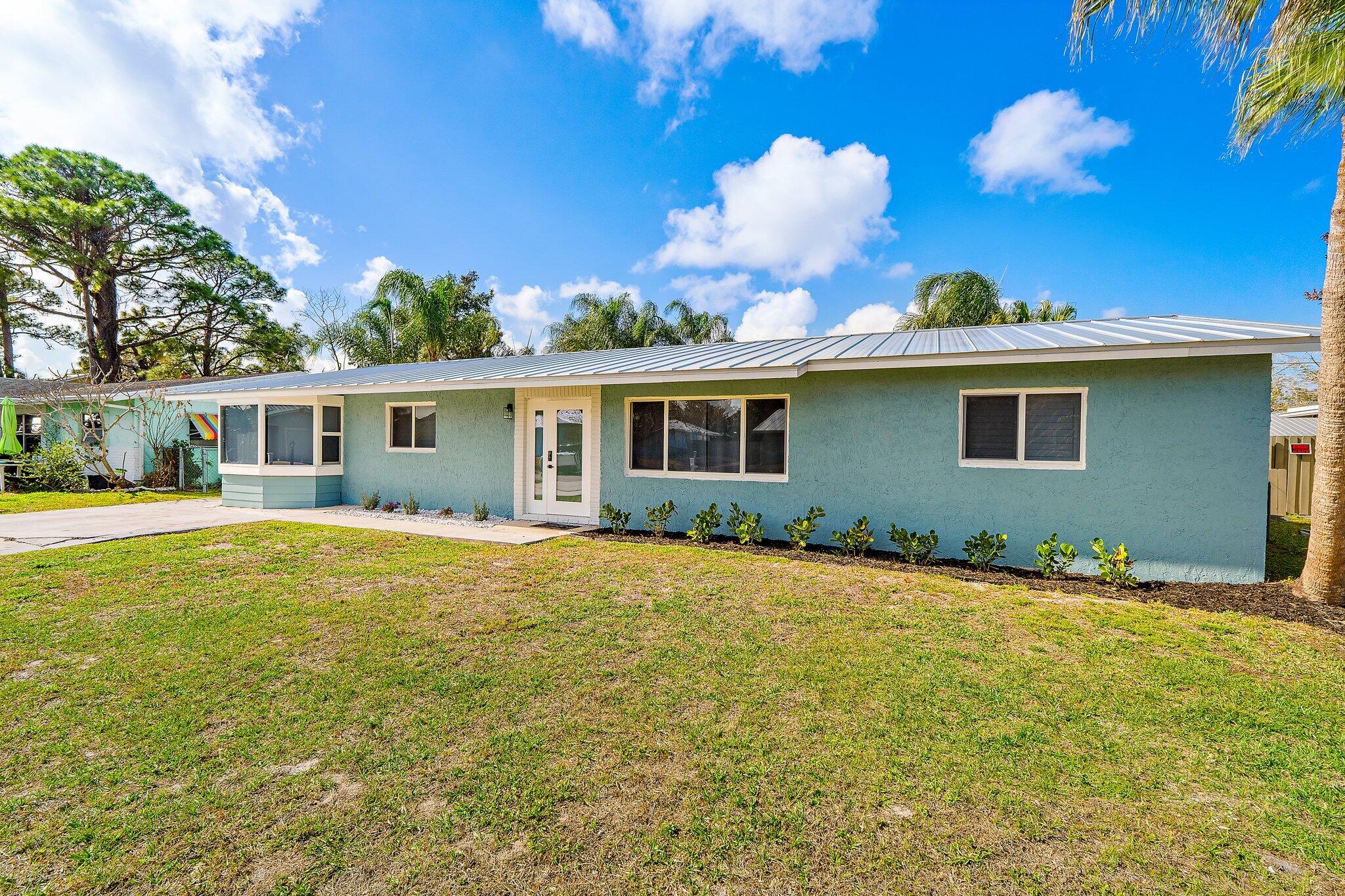 1851 Southeast Jackson Street Stuart, FL 34997 - Photo 8 of 61 a view of a house with a backyard