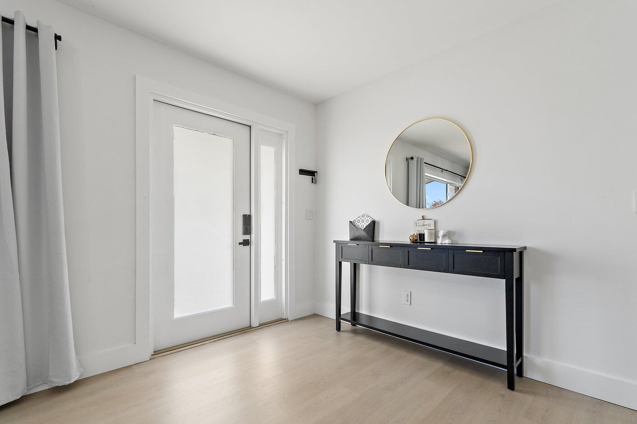 1851 Southeast Jackson Street Stuart, FL 34997 - Photo 10 of 61 a room with a mirror and a wooden door