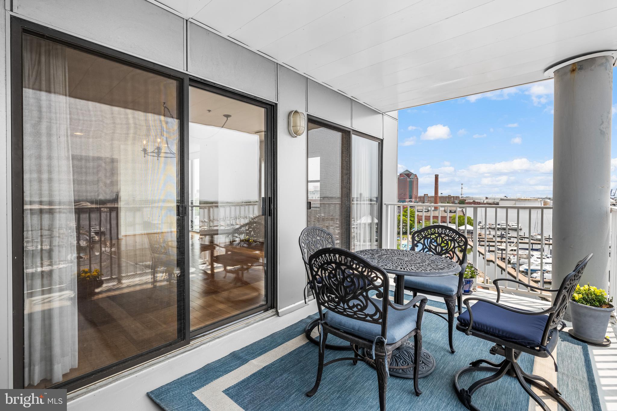 2702 Lighthouse Point East, Unit 638 Baltimore, MD 21224 - Photo 27 of 72 a living room with furniture and a floor to ceiling window
