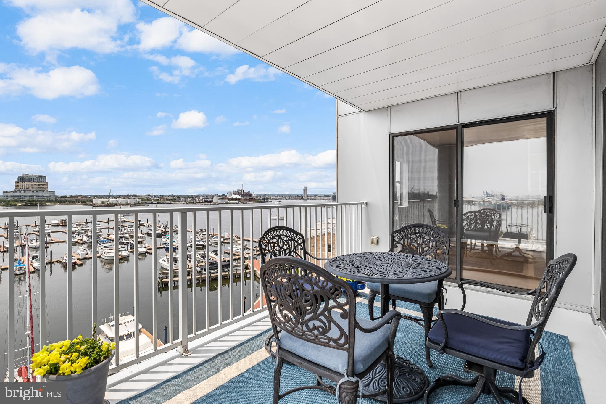 2702 Lighthouse Point East, Unit 638 Baltimore, MD 21224 - Photo 28 of 72 a view of a chairs and table on the roof deck