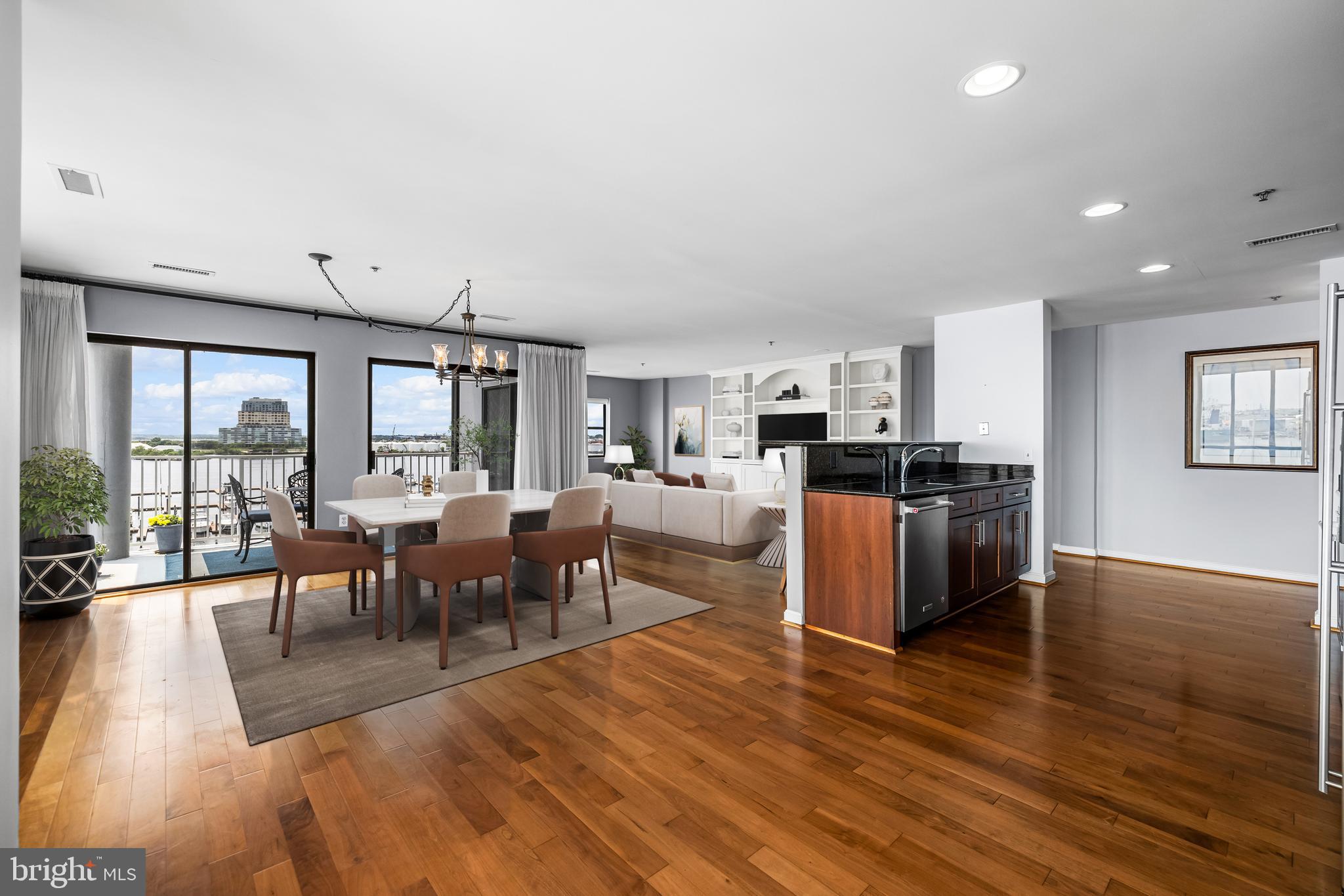 2702 Lighthouse Point East, Unit 638 Baltimore, MD 21224 - Photo 3 of 72 a living room with lots of furniture wooden floor and a kitchen view