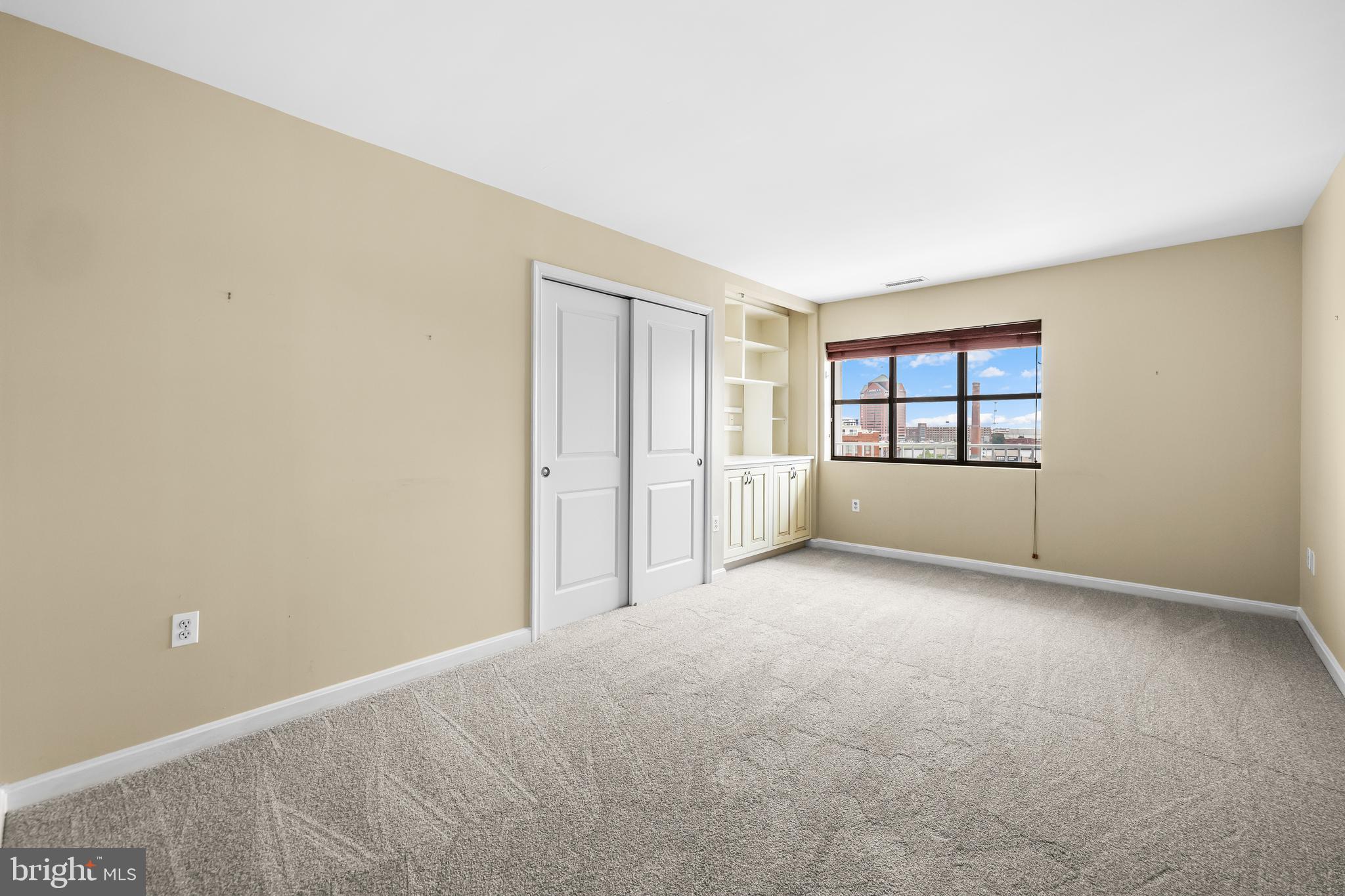 2702 Lighthouse Point East, Unit 638 Baltimore, MD 21224 - Photo 35 of 72 an empty room with windows and closet