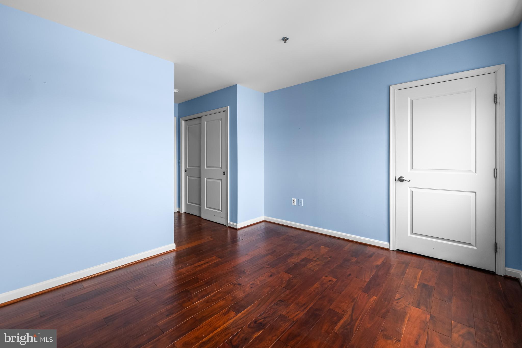 2702 Lighthouse Point East, Unit 638 Baltimore, MD 21224 - Photo 41 of 72 a view of an empty room with wooden floor and closet