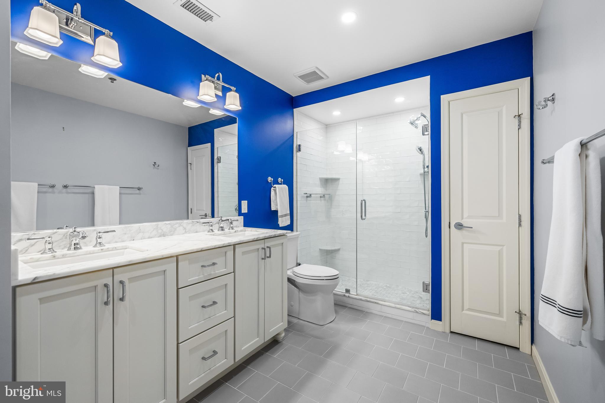 2702 Lighthouse Point East, Unit 638 Baltimore, MD 21224 - Photo 44 of 72 a spacious bathroom with a granite countertop sink toilet and shower