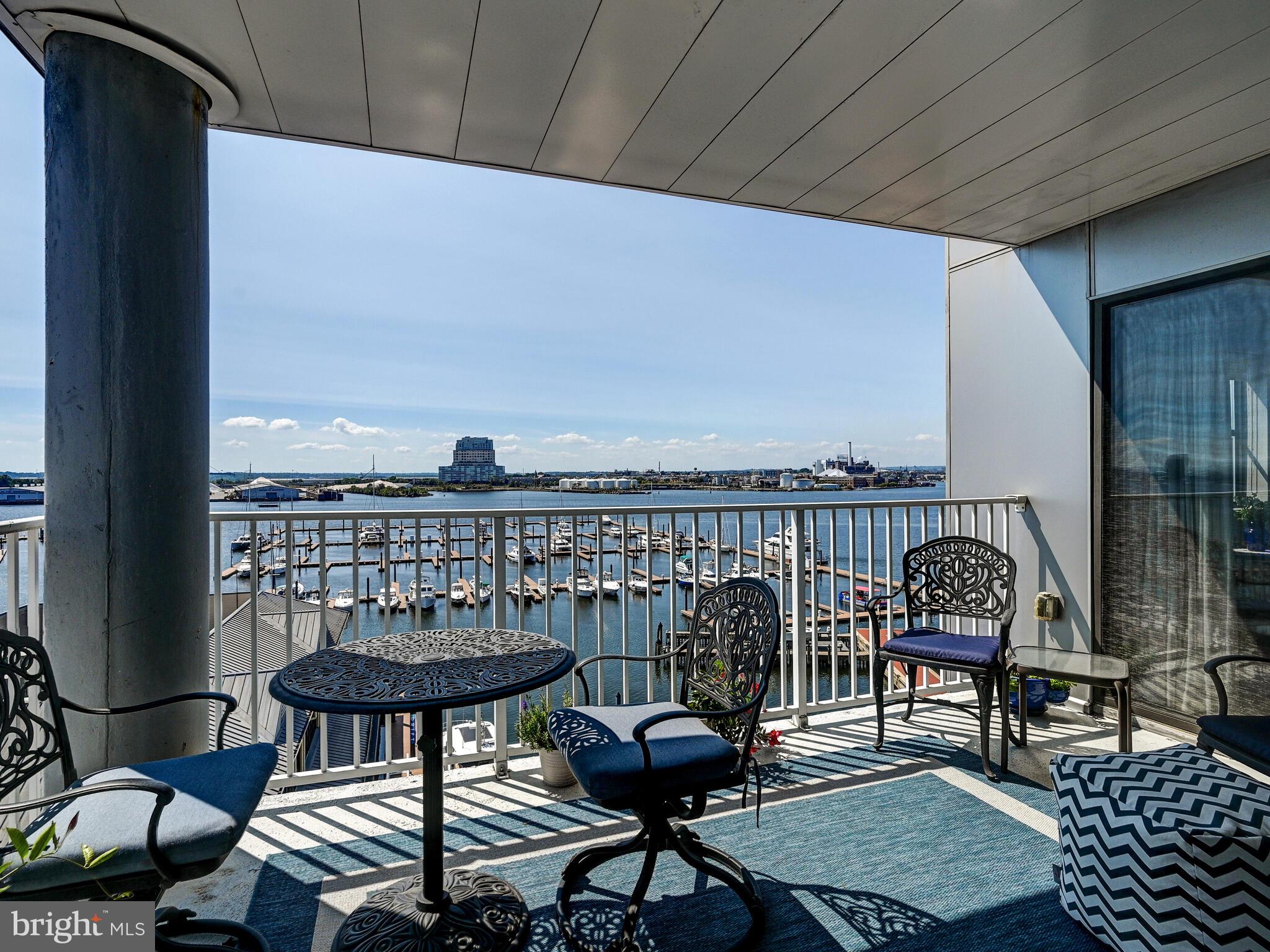2702 Lighthouse Point East, Unit 638 Baltimore, MD 21224 - Photo 46 of 72 a view of a balcony with chairs
