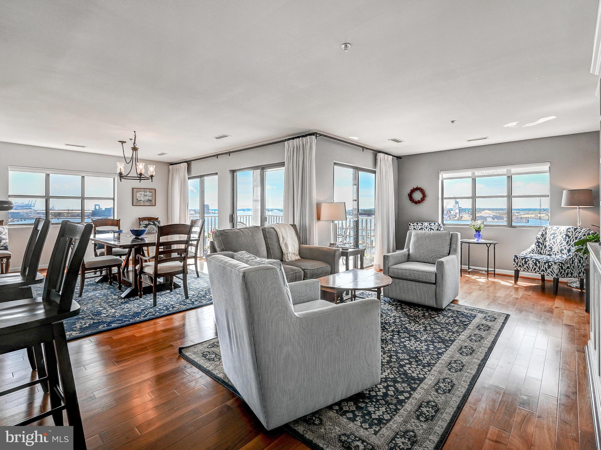 2702 Lighthouse Point East, Unit 638 Baltimore, MD 21224 - Photo 7 of 72 a living room with furniture and wooden floor
