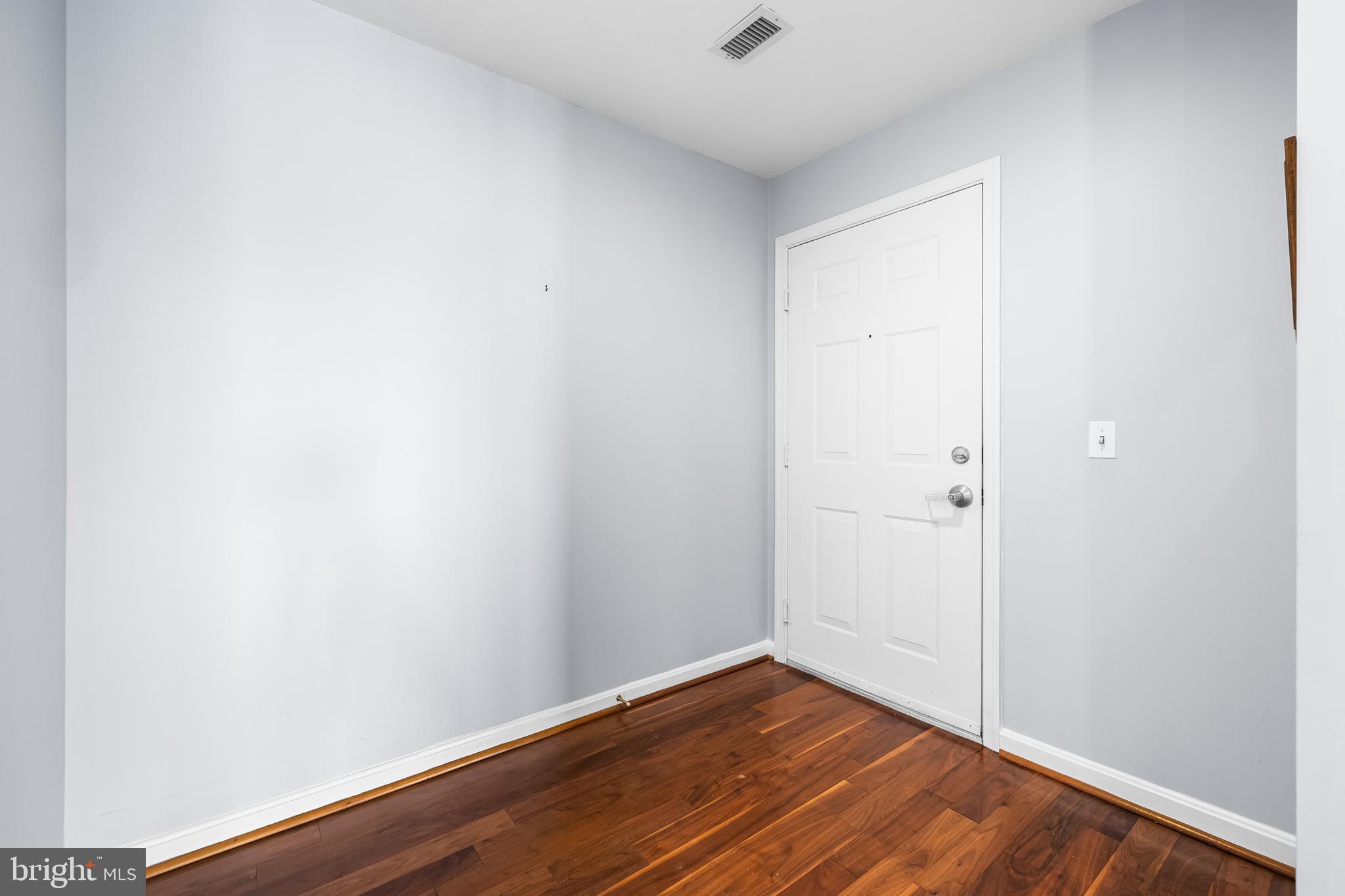 2702 Lighthouse Point East, Unit 638 Baltimore, MD 21224 - Photo 9 of 72 a view of an empty room with wooden floor