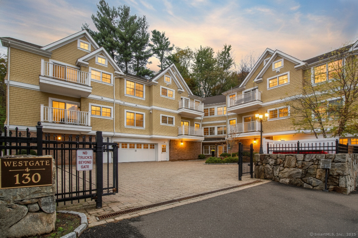 a front view of multi story residential apartment building with garage