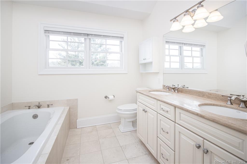 130 Post Road West, Unit PH Westport, CT 06880 - Photo 12 of 21 a spacious bathroom with a granite countertop sink a toilet and a bathtub