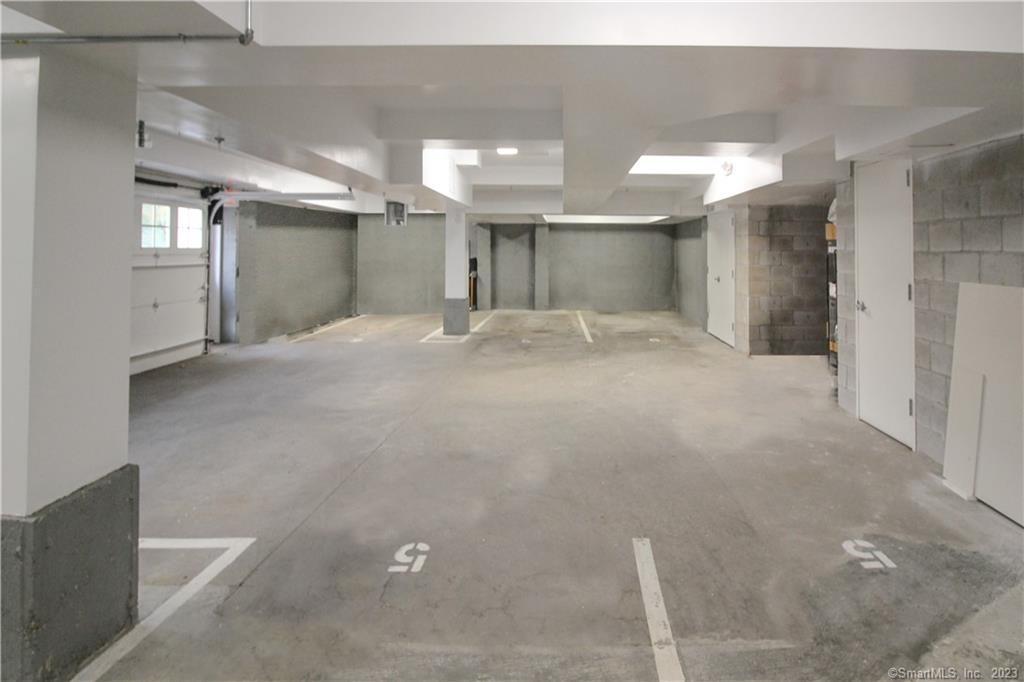 130 Post Road West, Unit PH Westport, CT 06880 - Photo 20 of 21 a view of a hallway with windows and chandelier