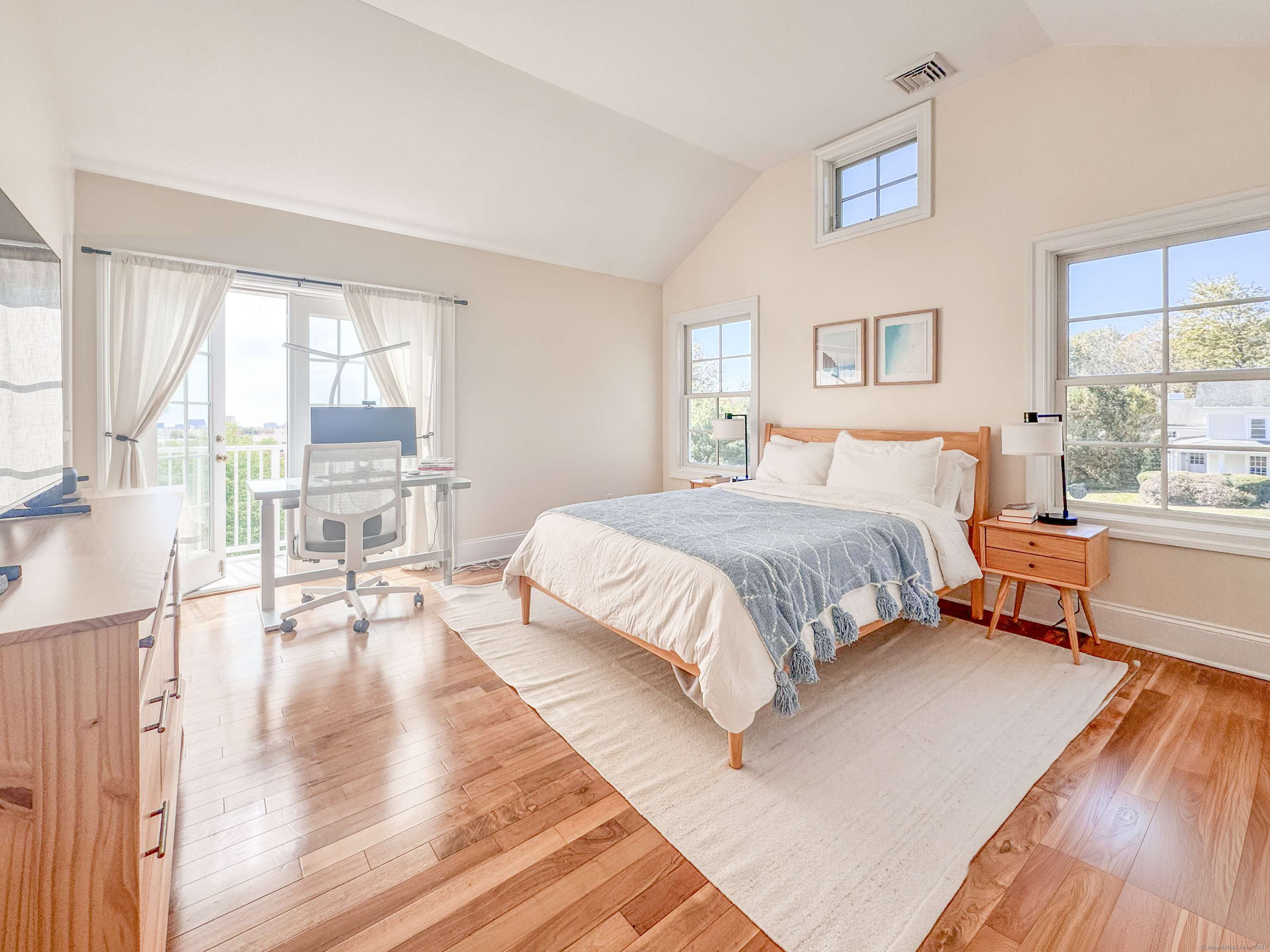 130 Post Road West, Unit PH Westport, CT 06880 - Photo 8 of 21 a bedroom with a bed and a large window