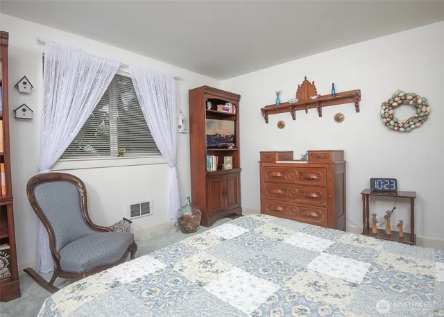 a bedroom with a bed and a chair