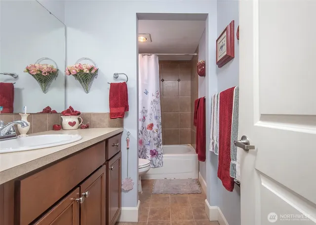 a bathroom with a sink vanity and a mirror