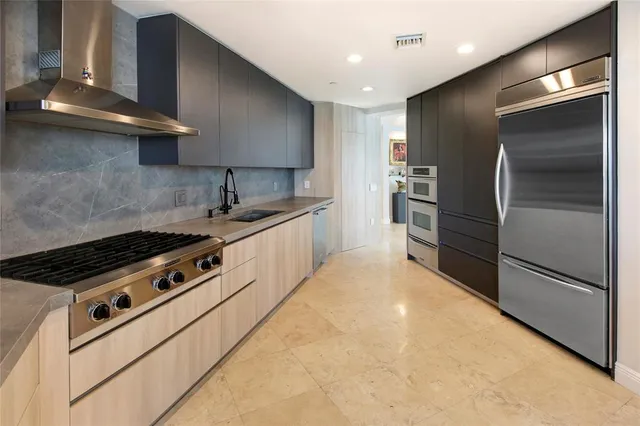 a kitchen with stainless steel appliances granite countertop a refrigerator and a sink