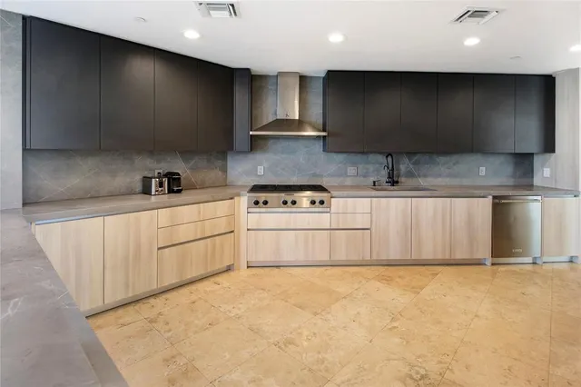 a kitchen with stainless steel appliances a sink a stove a microwave and cabinets