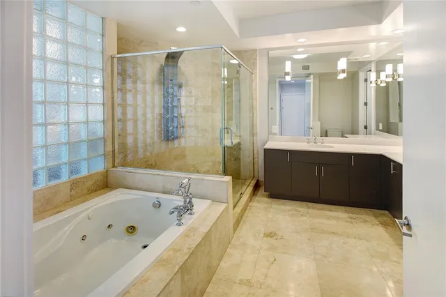 a bathroom with a tub a sink shower and mirror