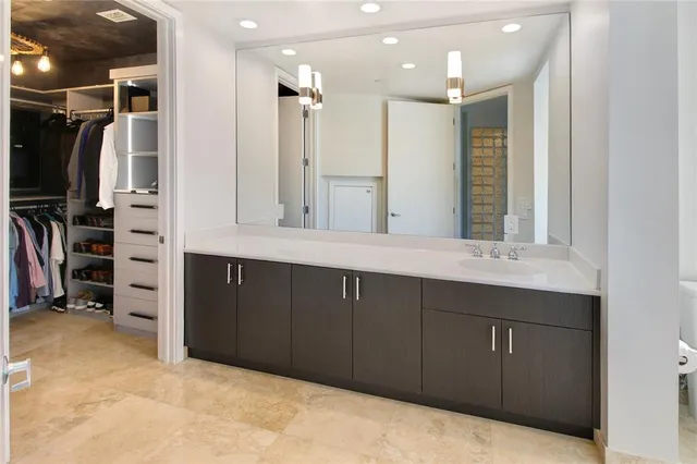 a bathroom with a double vanity sink and a large mirror
