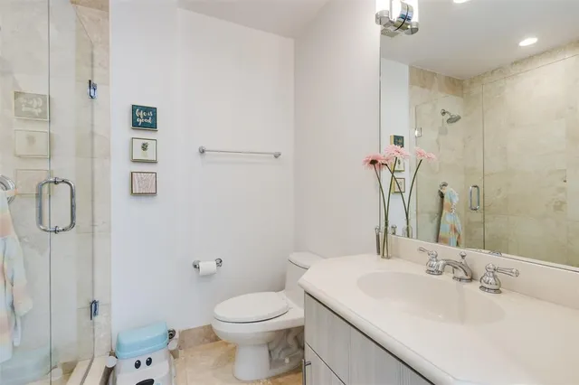 a bathroom with a sink toilet and shower