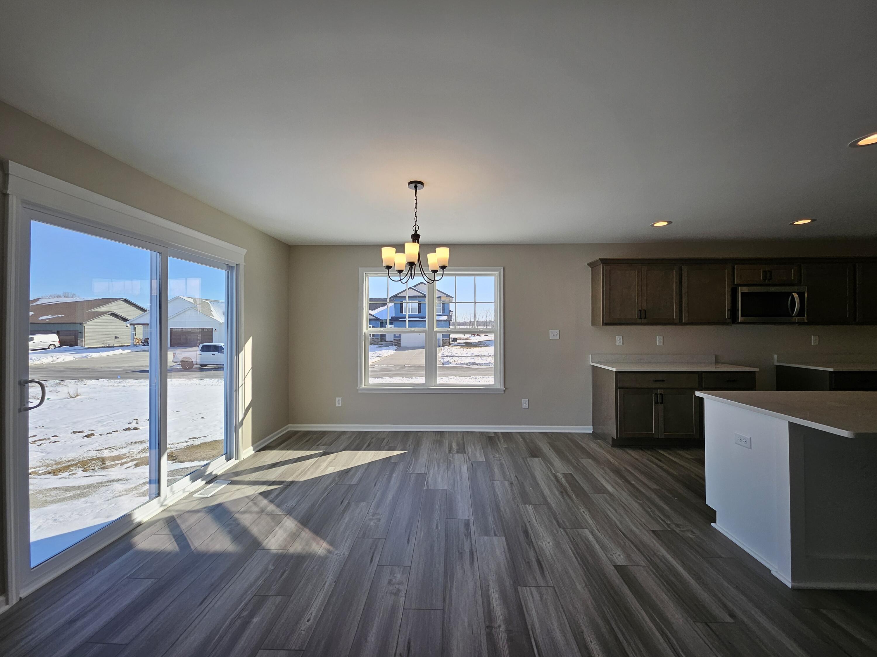 18348 Alexander Avenue Lowell, IN 46356 - Photo 12 of 46 an open kitchen with wooden floor and window