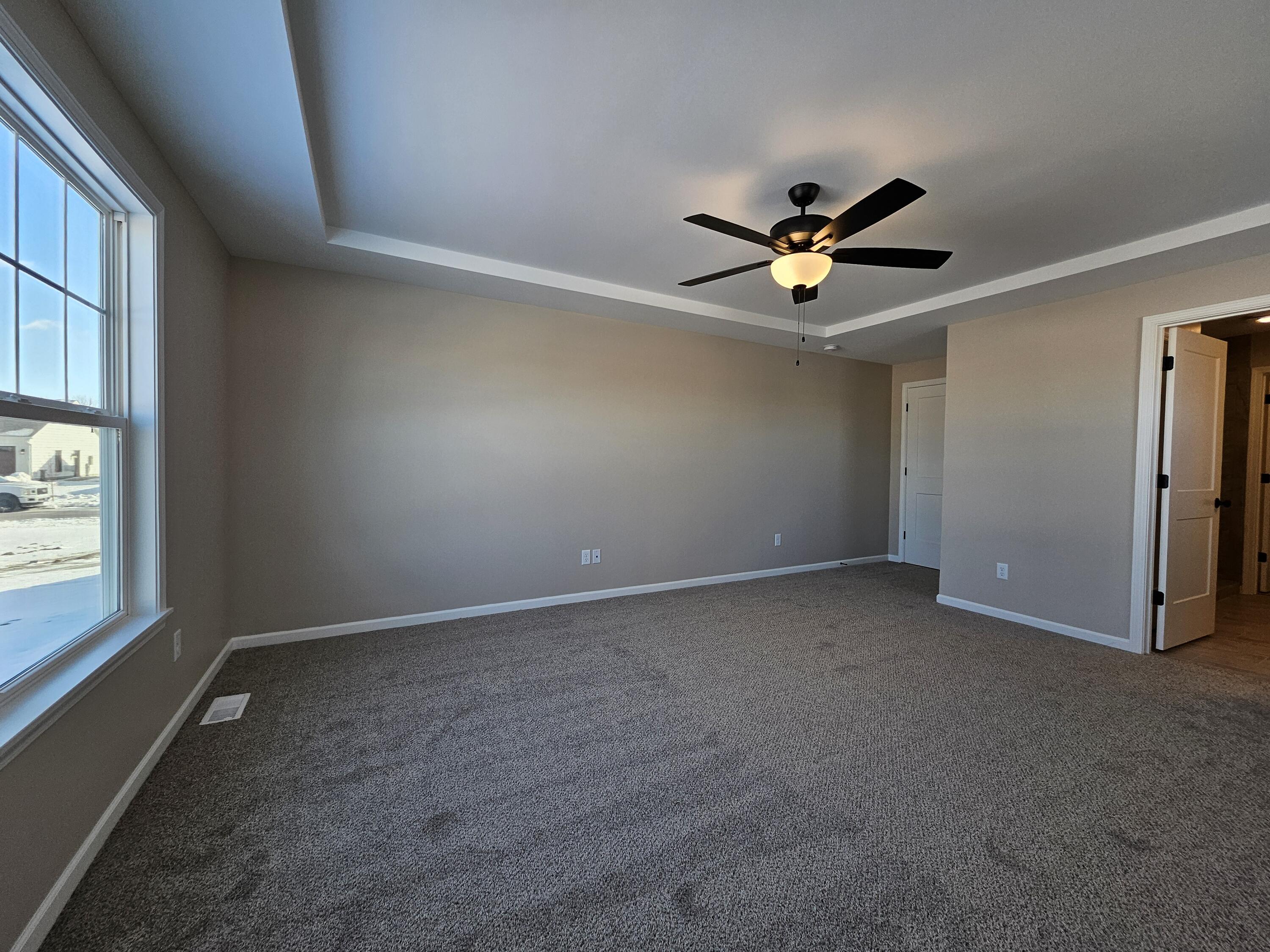 18348 Alexander Avenue Lowell, IN 46356 - Photo 24 of 46 an empty room with windows and ceiling fan