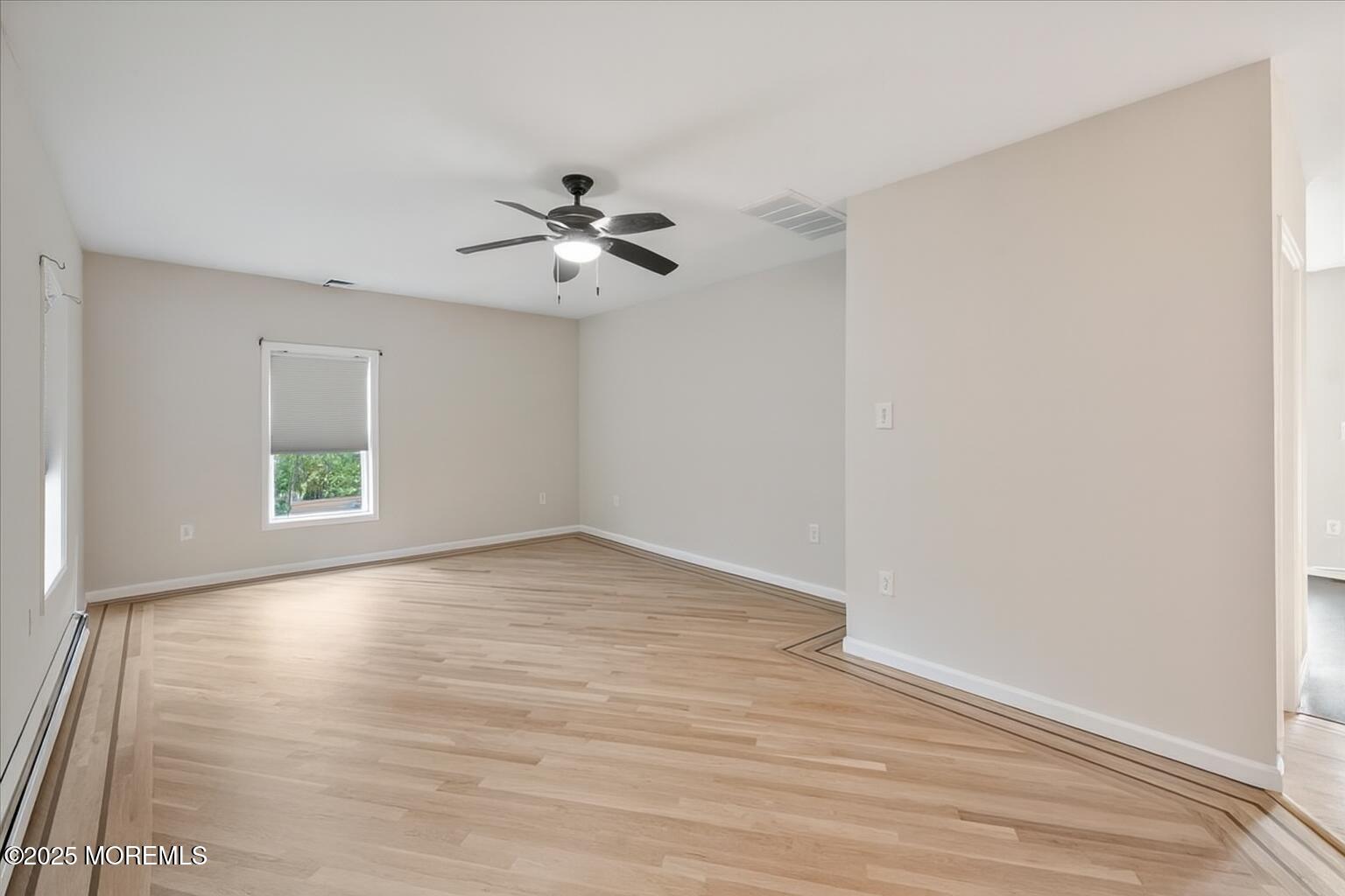 1621 Martin Road Neptune, NJ 07753 - Photo 18 of 54 a view of empty room with wooden floor and fan