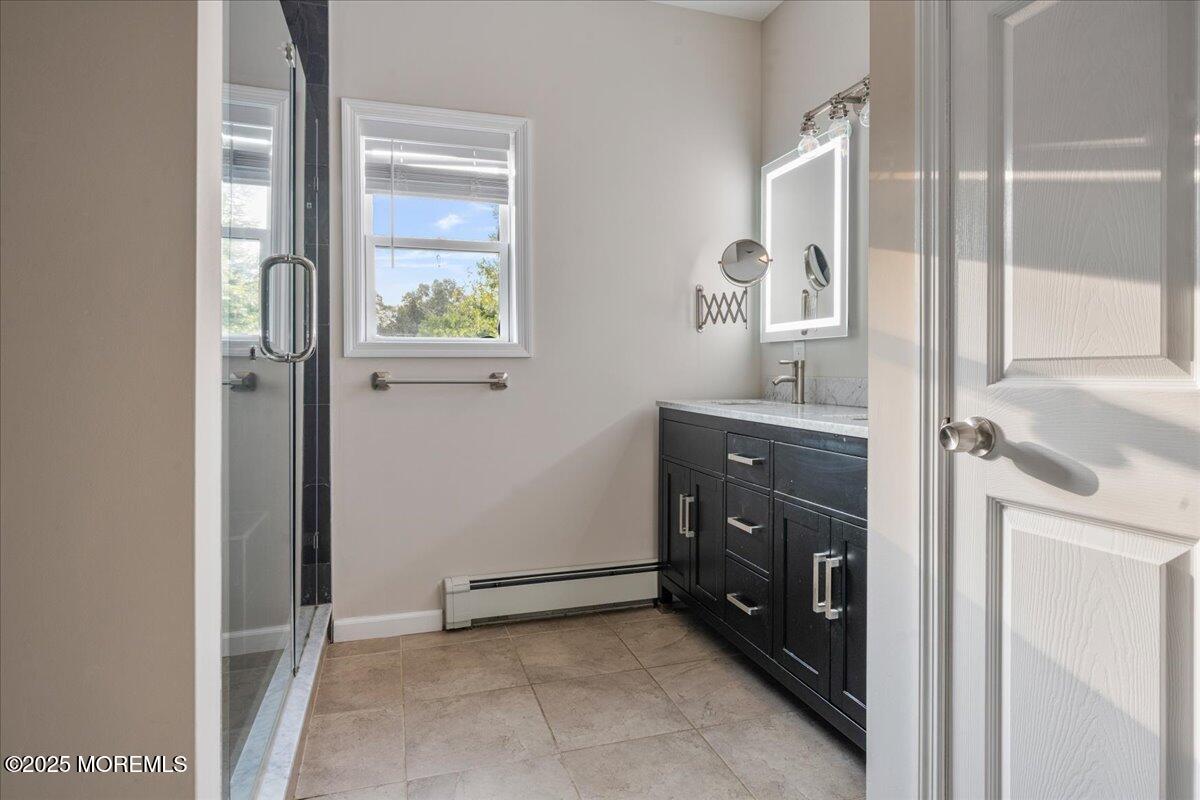 1621 Martin Road Neptune, NJ 07753 - Photo 26 of 54 a bathroom with a sink a mirror and a window