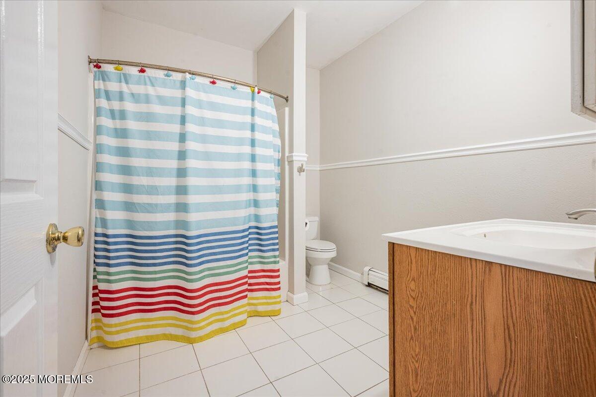 1621 Martin Road Neptune, NJ 07753 - Photo 27 of 54 a bathroom with a sink and a shower curtain