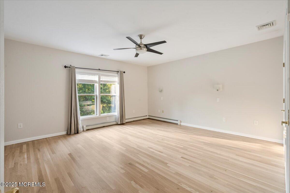 1621 Martin Road Neptune, NJ 07753 - Photo 29 of 54 wooden floor in an empty room with a window