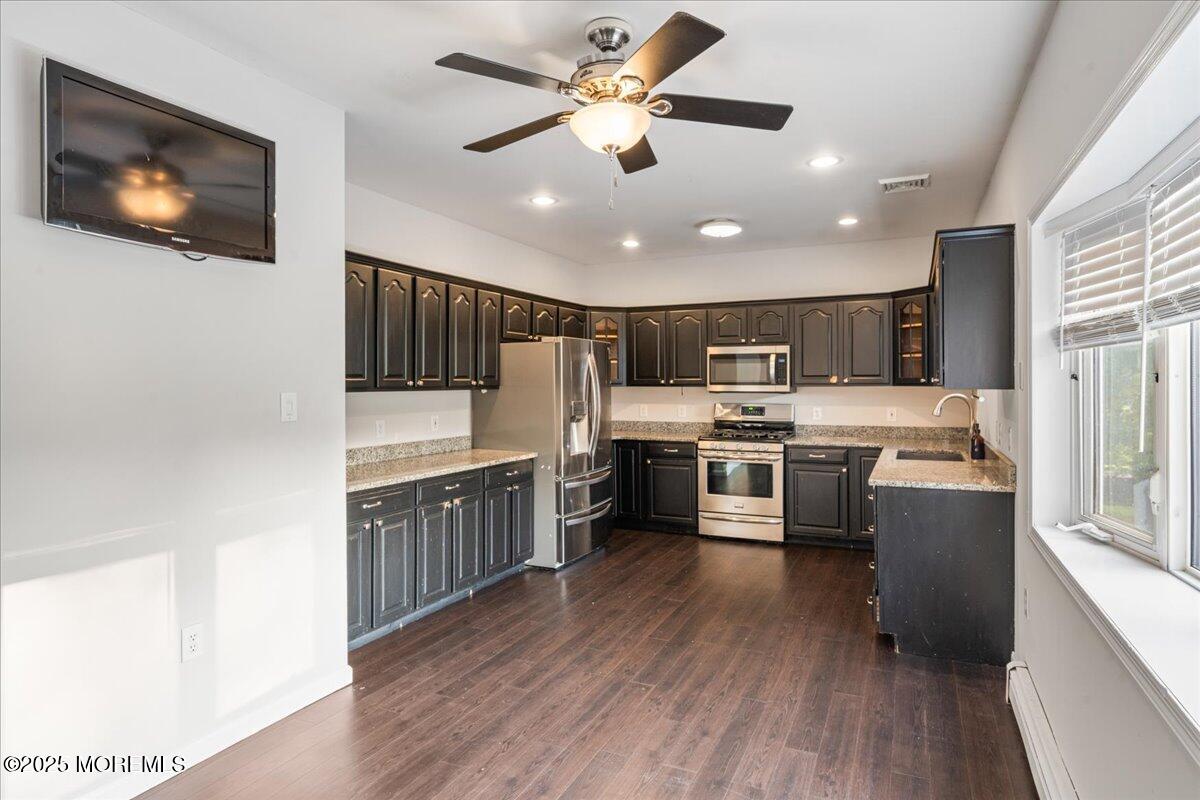 1621 Martin Road Neptune, NJ 07753 - Photo 32 of 54 a kitchen with stainless steel appliances a sink a stove top oven a counter space and cabinets
