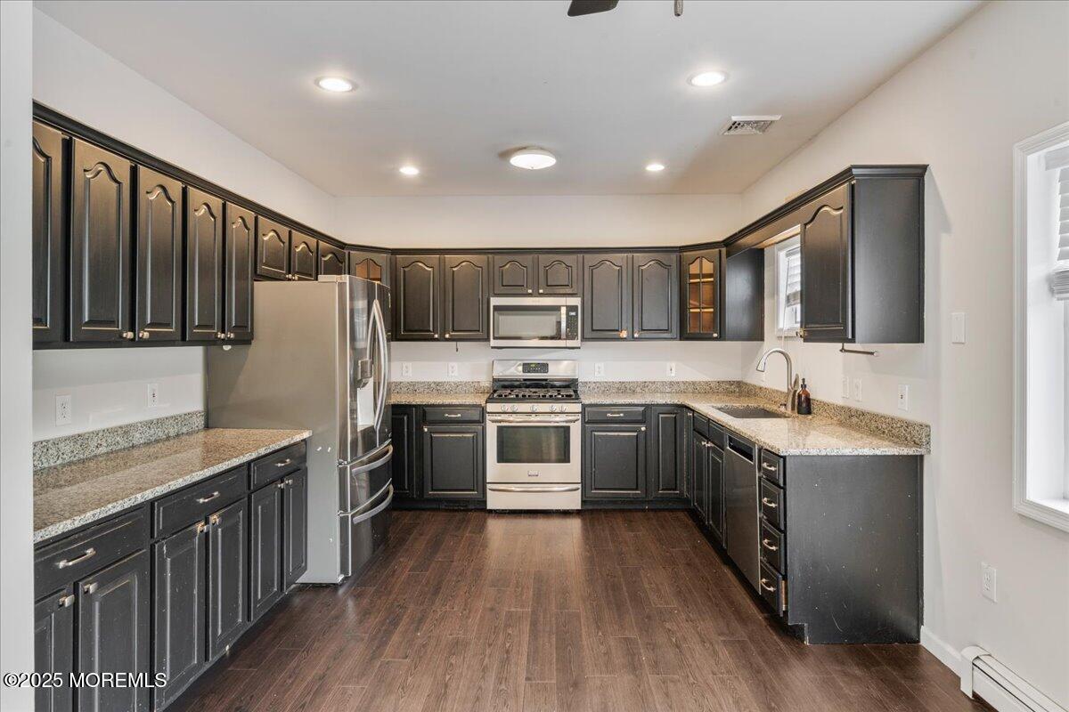 1621 Martin Road Neptune, NJ 07753 - Photo 34 of 54 a kitchen with stainless steel appliances granite countertop refrigerator a stove top oven a sink dishwasher and wooden cabinets with wooden floor